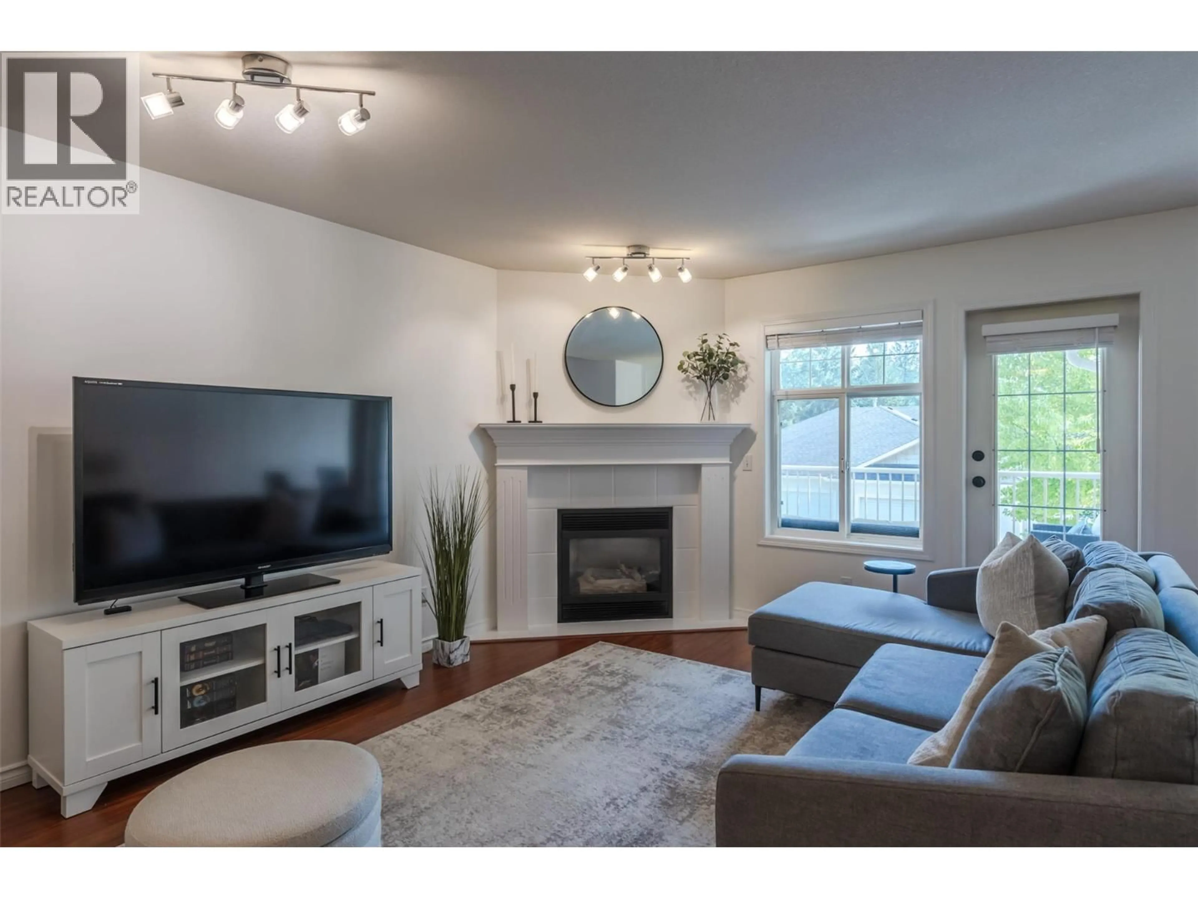 Living room with furniture, wood/laminate floor for 103 - 3825 GLEN CANYON DRIVE, West Kelowna British Columbia V4T2T4