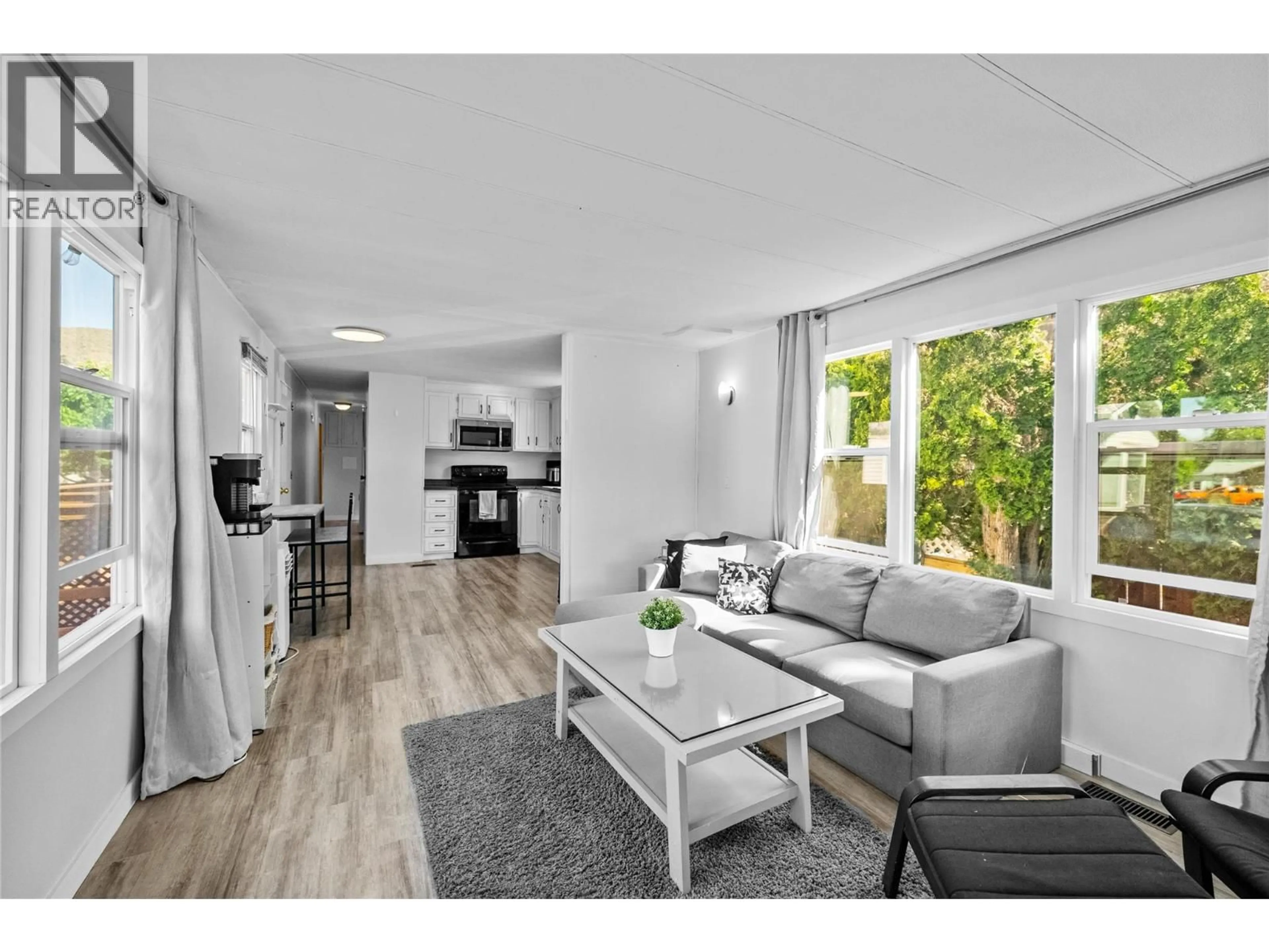 Living room with furniture, wood/laminate floor for 107 - 2401 ORD ROAD, Kamloops British Columbia V2B7V8