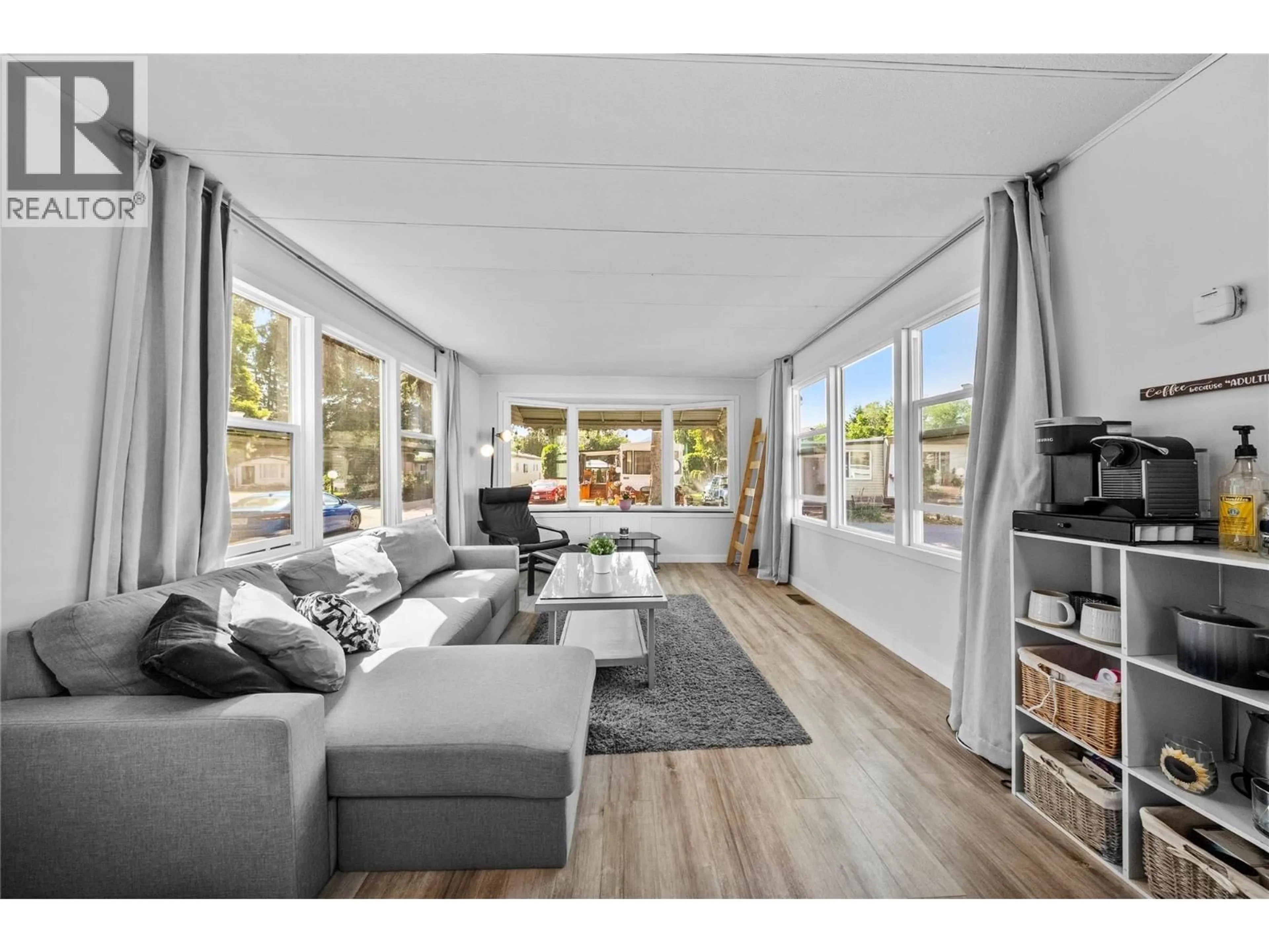 Living room with furniture, wood/laminate floor for 107 - 2401 ORD ROAD, Kamloops British Columbia V2B7V8