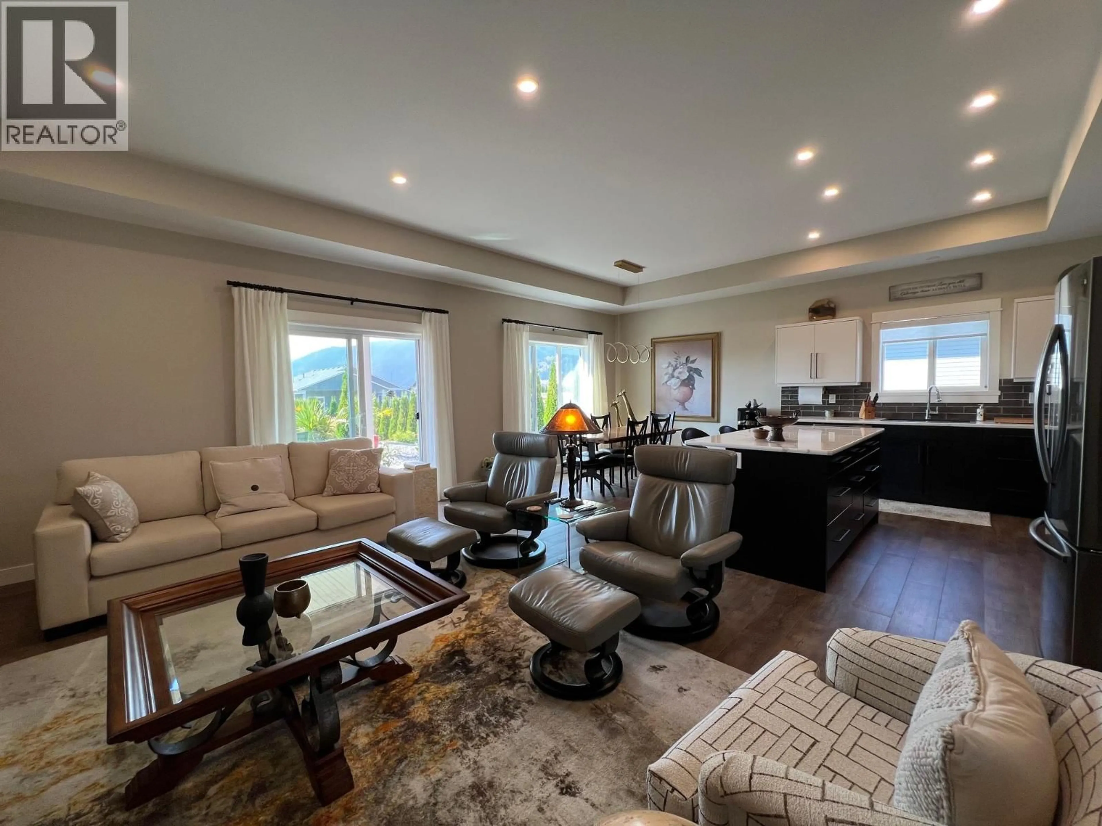 Living room with furniture, wood/laminate floor for 1019 10TH AVENUE, Vernon British Columbia V1H1Z1