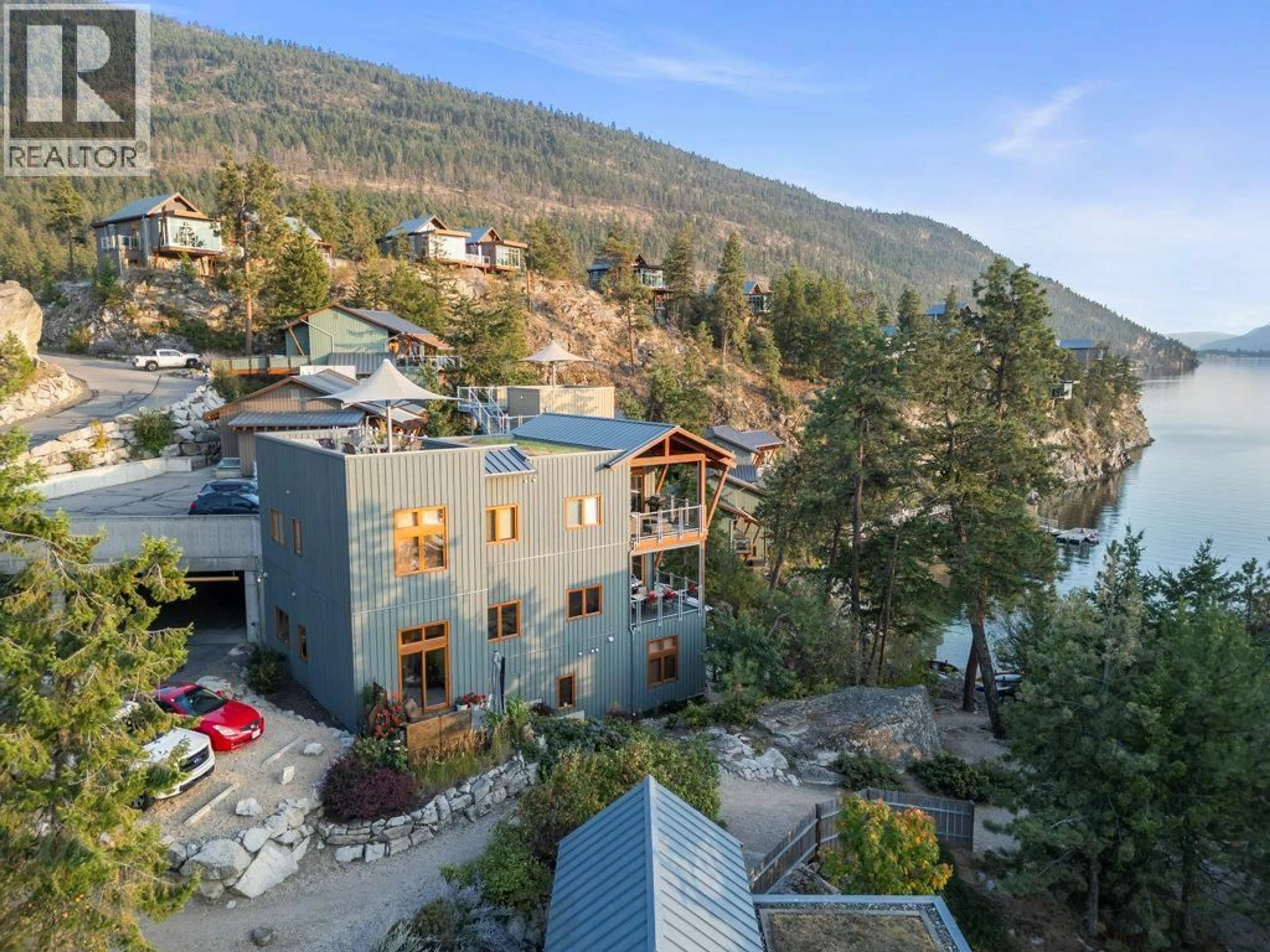 A pic from outside/outdoor area/front of a property/back of a property/a pic from drone, mountain view for 128 - 9845 EASTSIDE ROAD, Vernon British Columbia V1H1Z2