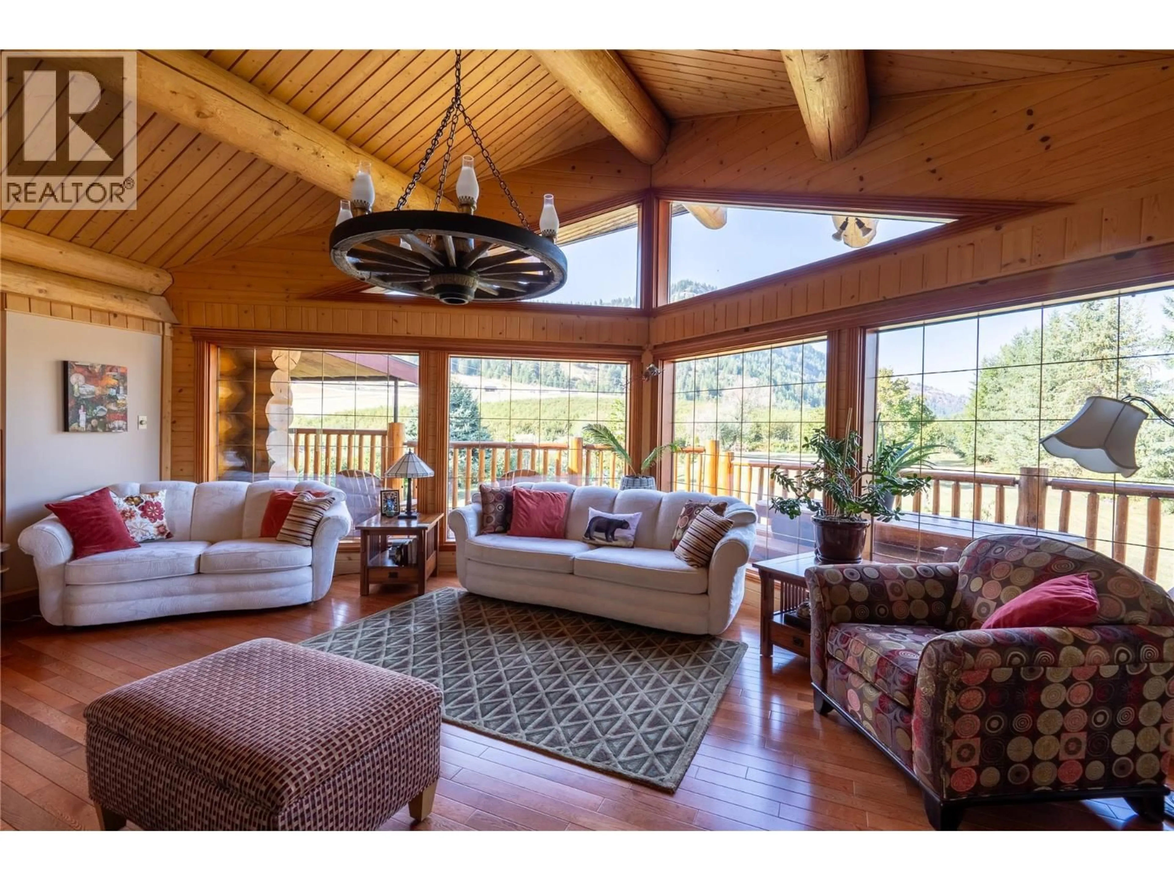 Living room with furniture, wood/laminate floor for 3486 DAVY ROAD, Grand Forks British Columbia V0H1H2
