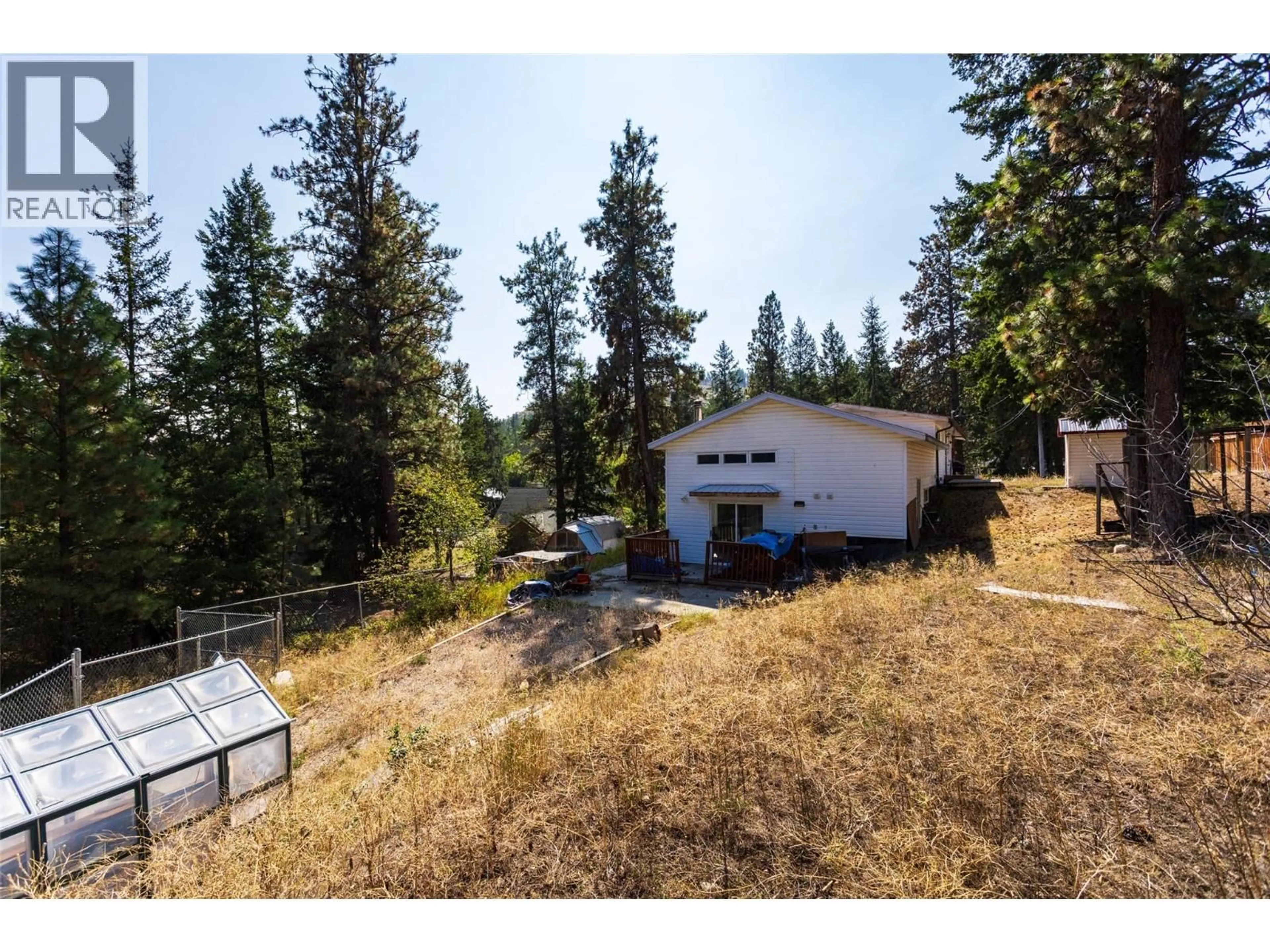 A pic from outside/outdoor area/front of a property/back of a property/a pic from drone, forest/trees view for 820 FIRWOOD ROAD, Kelowna British Columbia V1Z3V5