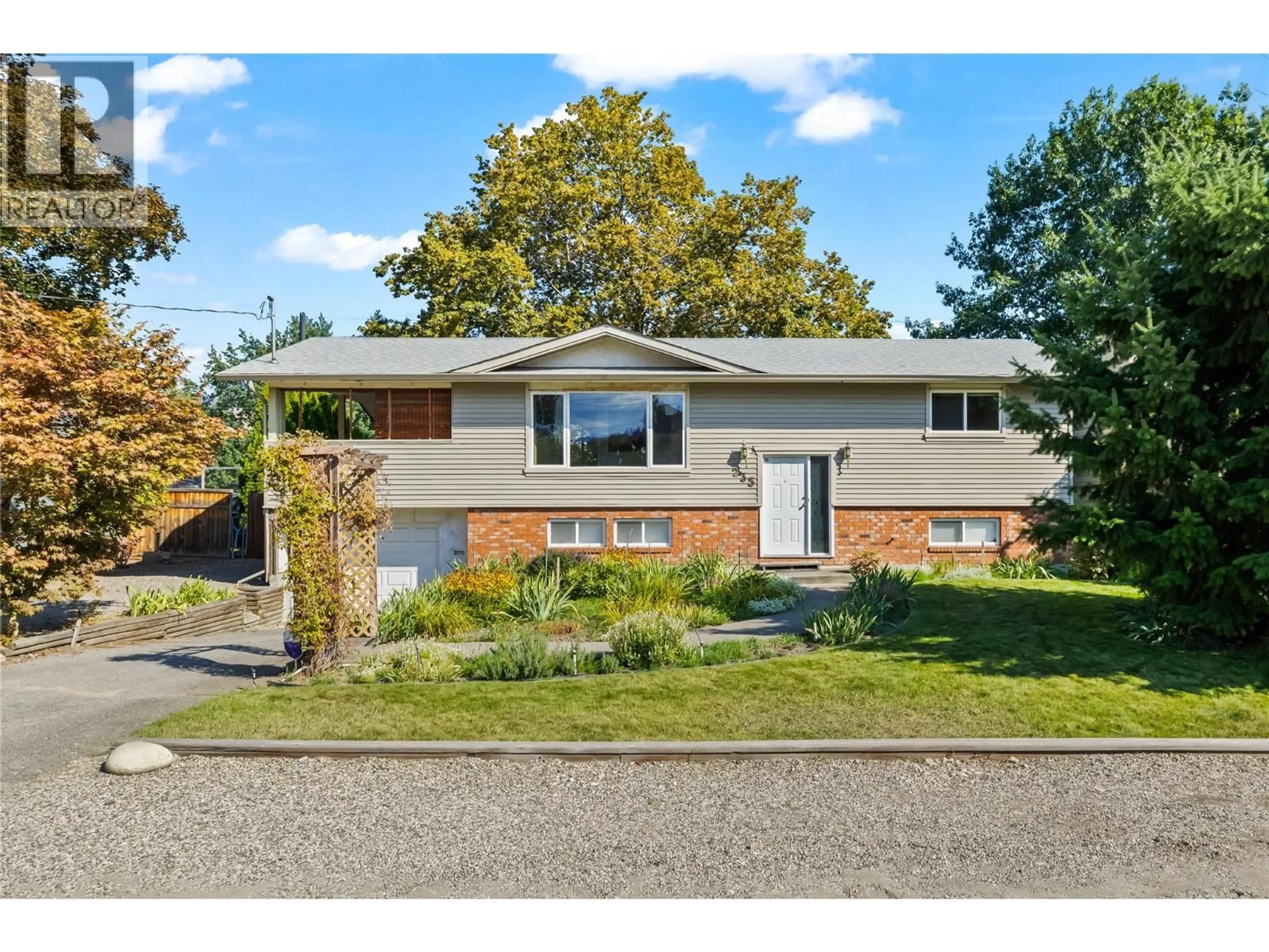 Home with vinyl exterior material, street for 235 KRIESE ROAD, Kelowna British Columbia V1X4Y2