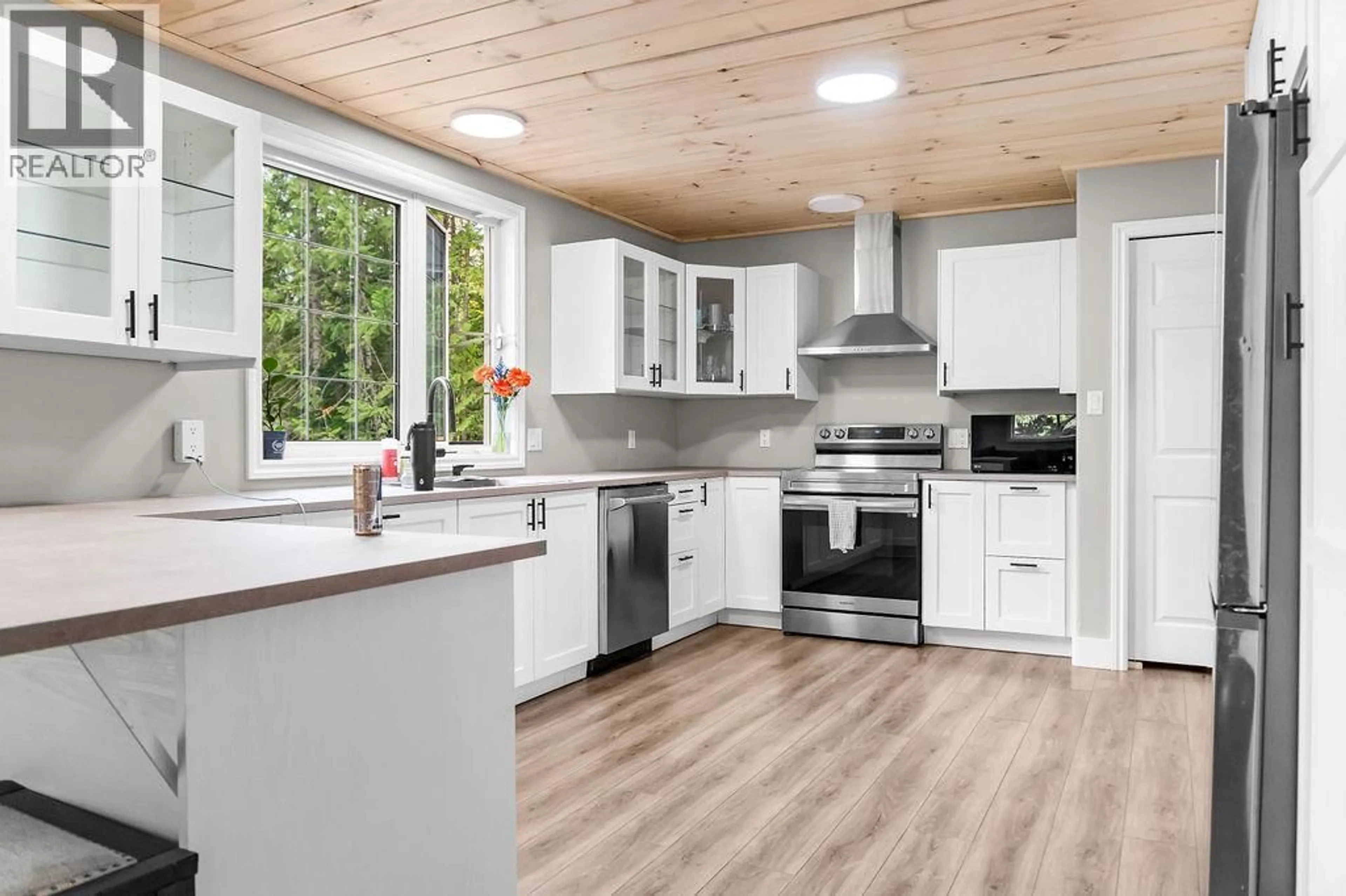 Open concept kitchen, wood/laminate floor for 2227 ALLSHOUSE ROAD, Summit Lake British Columbia V0G1R1