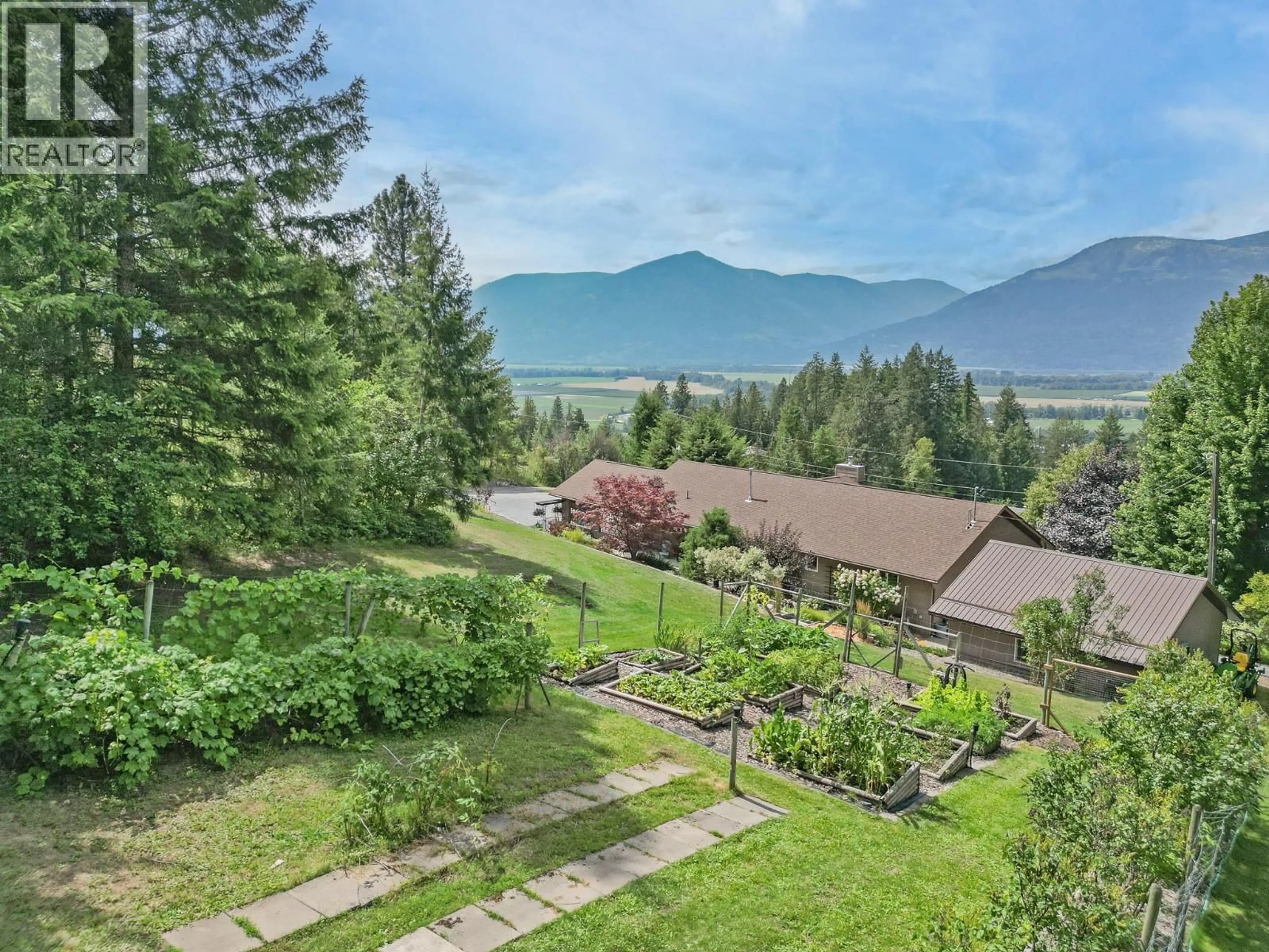 A pic from outside/outdoor area/front of a property/back of a property/a pic from drone, mountain view for 5126 BOSSIO ROAD, Wynndel British Columbia V0B2N1