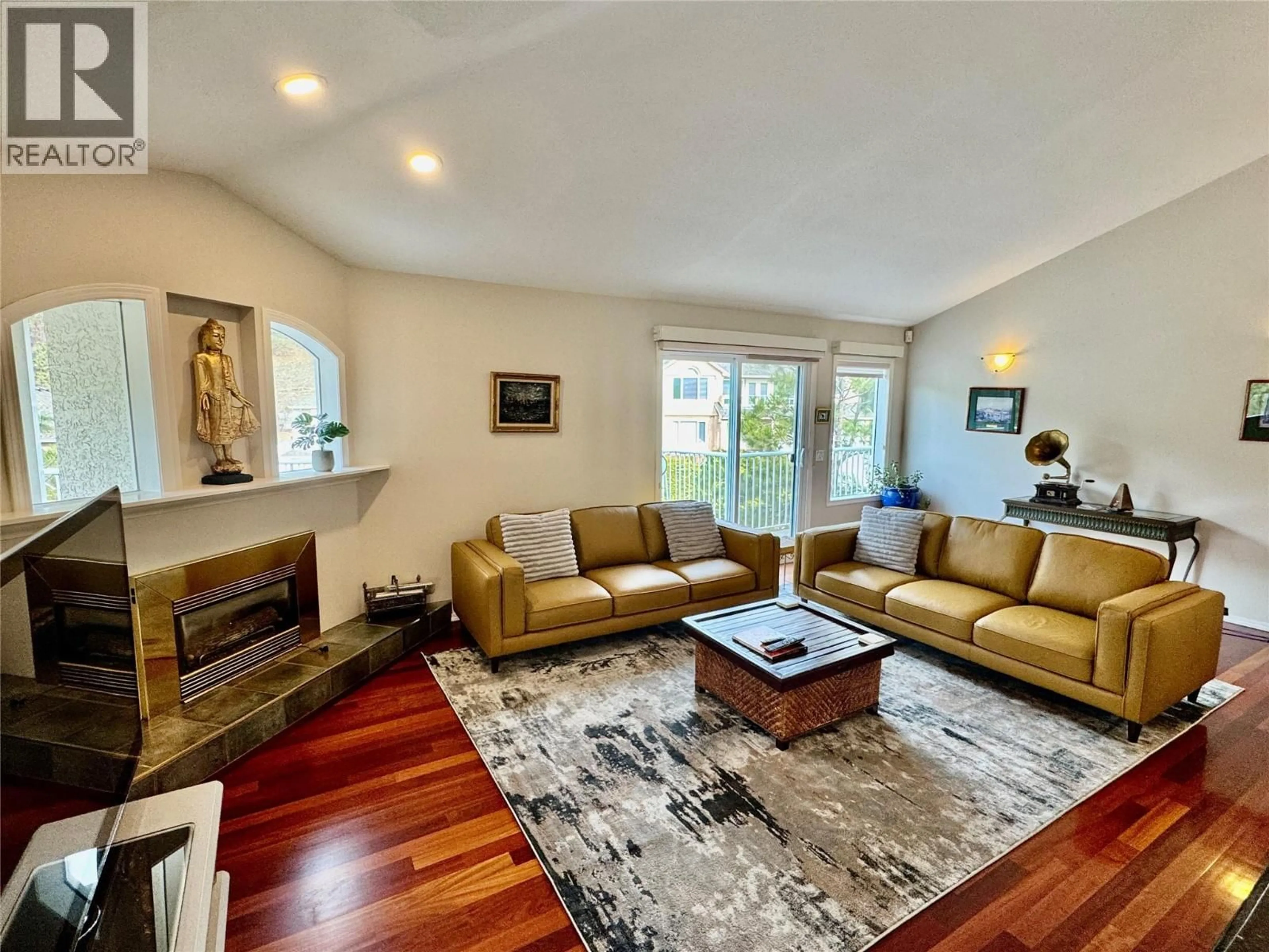 Living room with furniture, wood/laminate floor for 773 SIWASH COURT, Kelowna British Columbia V1V1N5