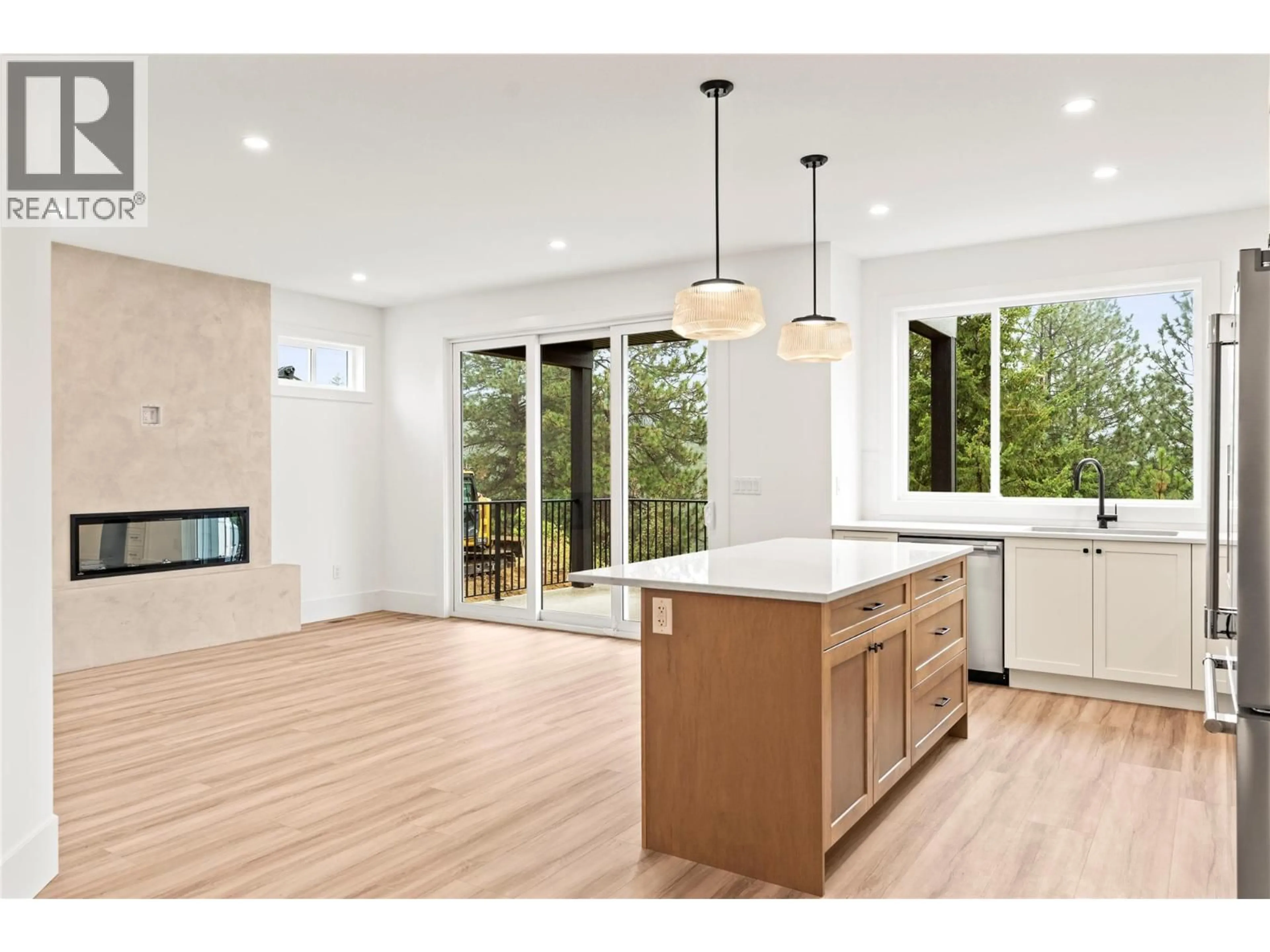 Open concept kitchen, wood/laminate floor for 7028 MANNING PLACE, Vernon British Columbia V1B0B6