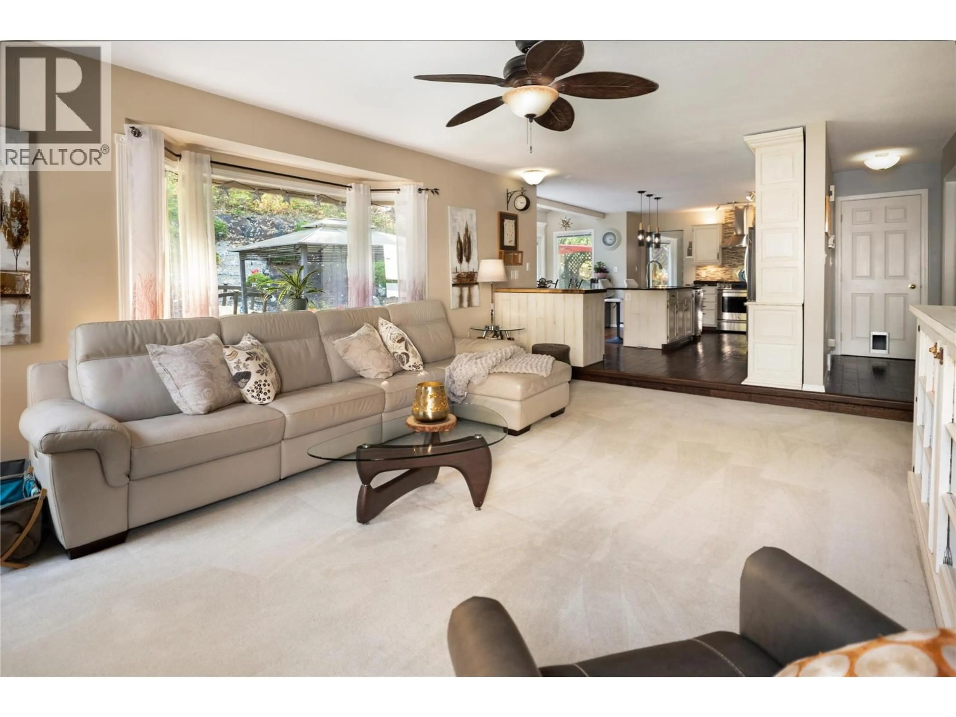 Living room with furniture, ceramic/tile floor for 4692 GORDON DRIVE, Kelowna British Columbia V1W4P4