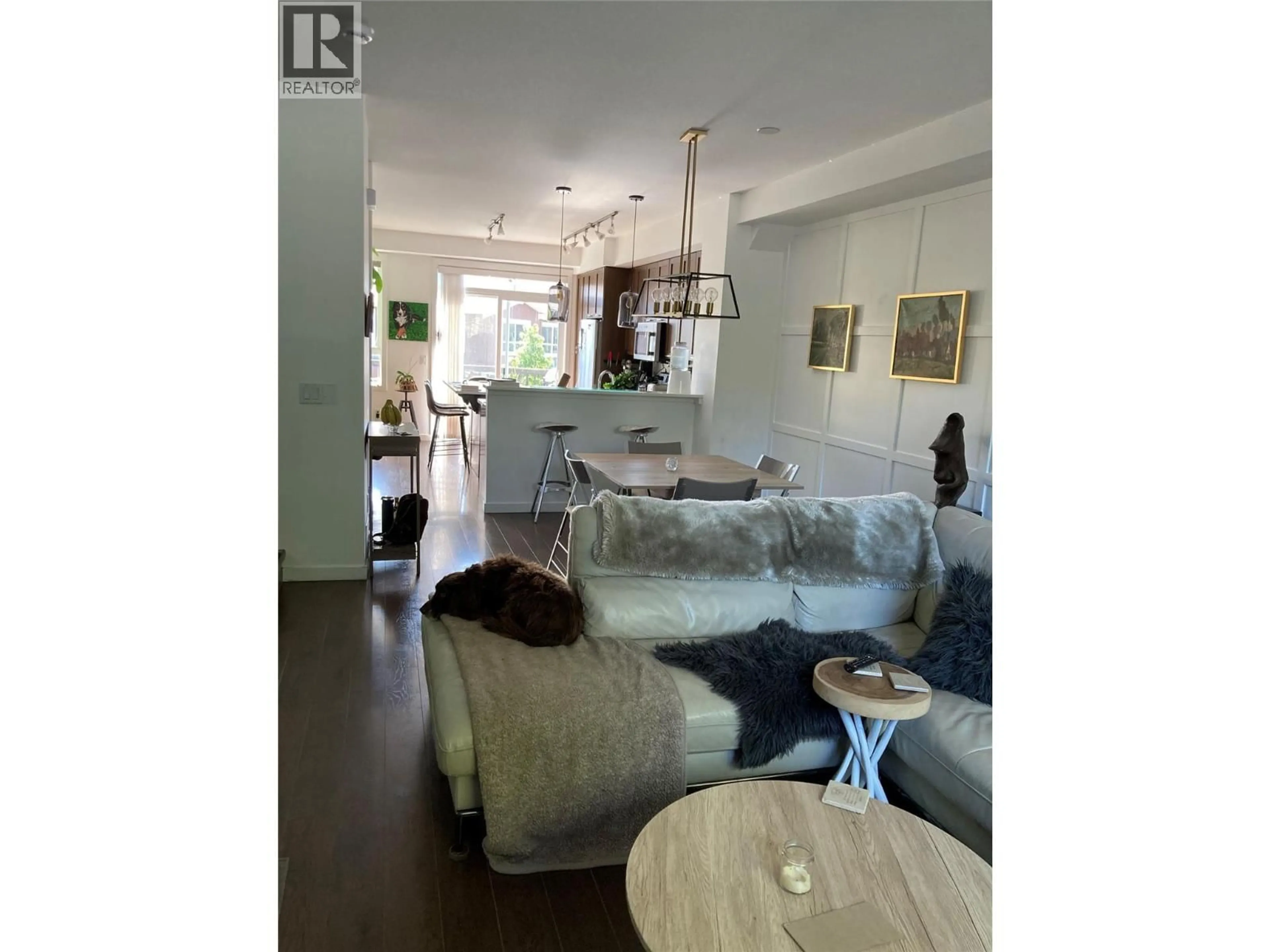 Living room with furniture, wood/laminate floor for 589 BOYNTON PLACE, Kelowna British Columbia V1V3B5