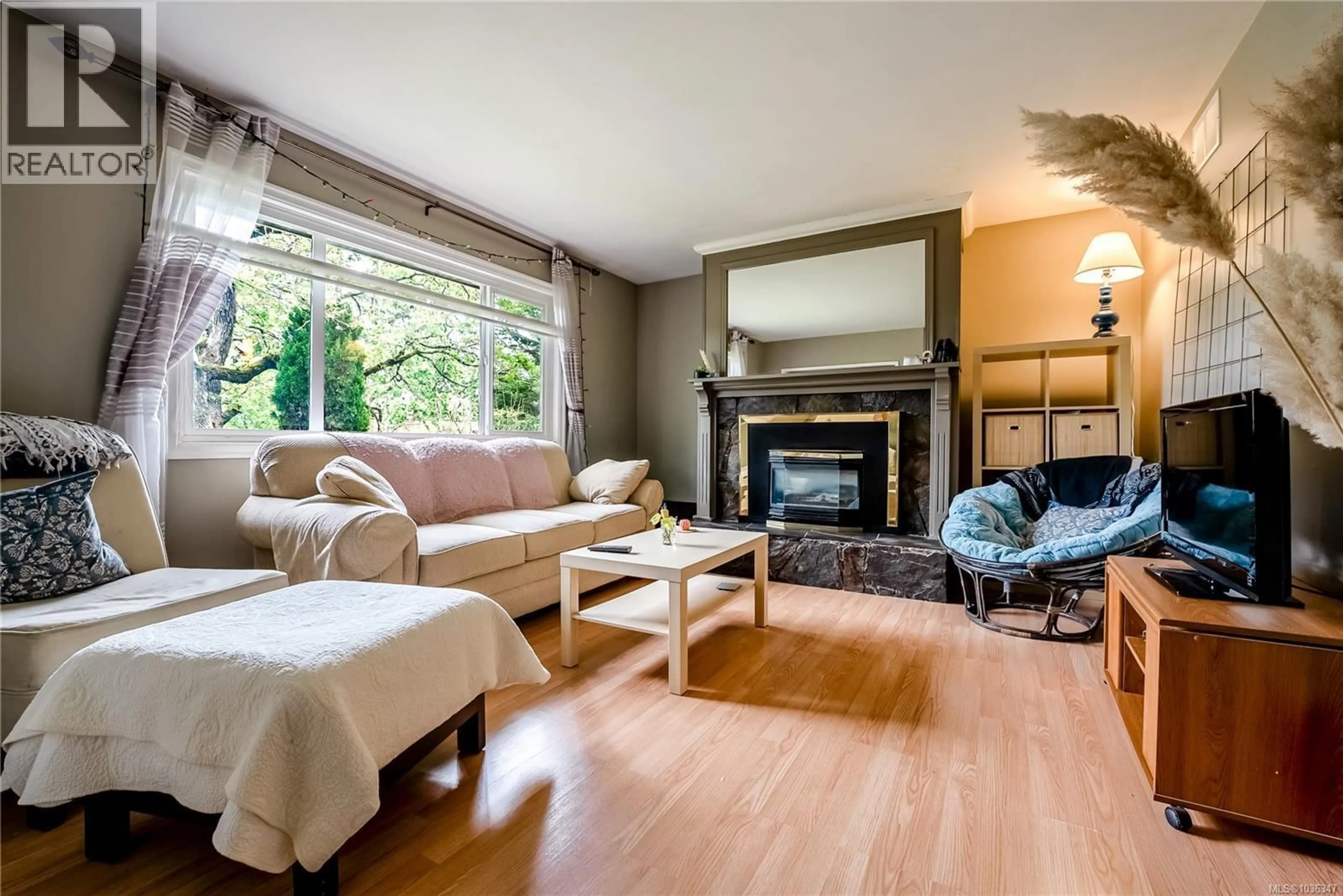 Living room with furniture, wood/laminate floor for 4120 QUADRA STREET, Saanich British Columbia V8X3B9