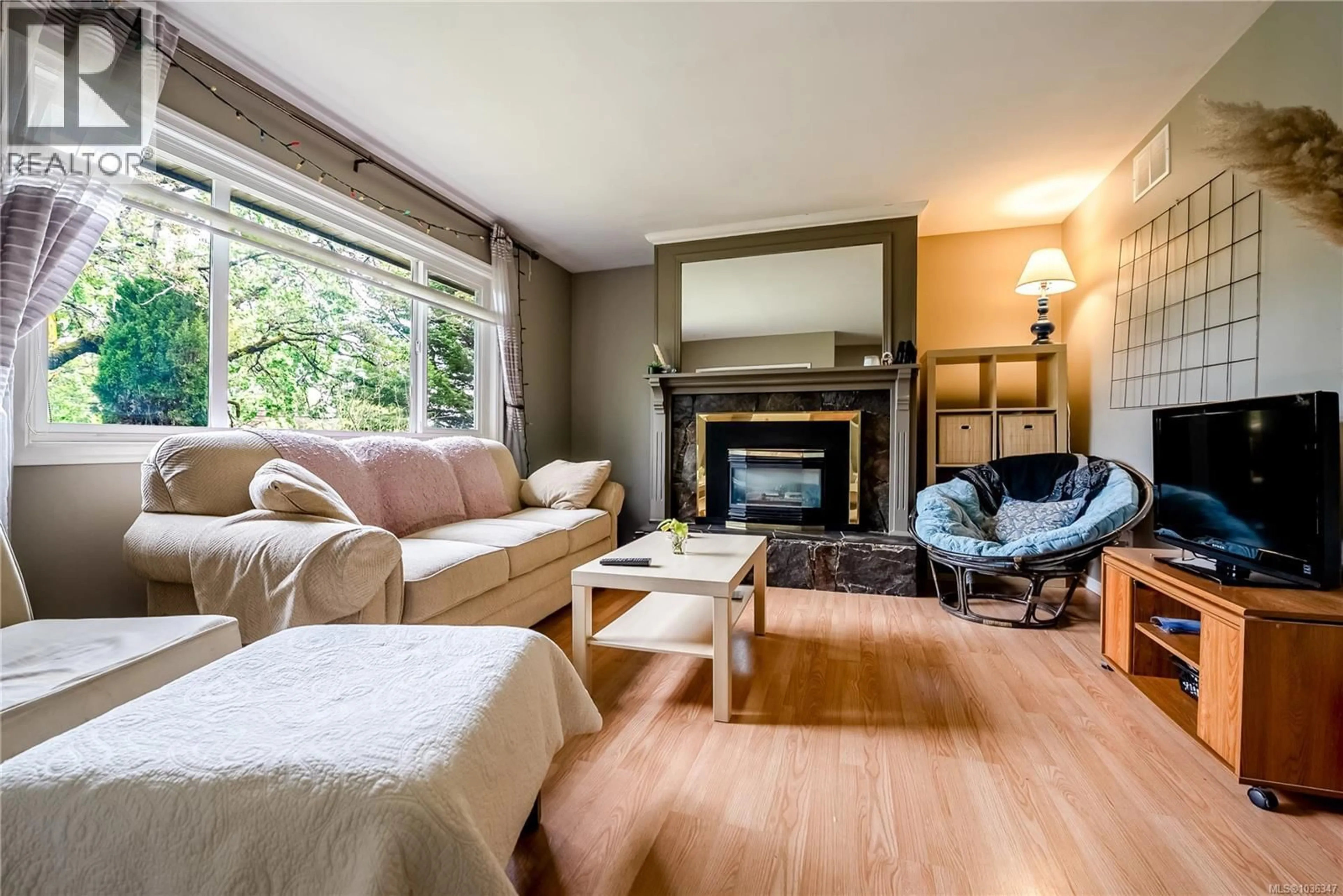 Living room with furniture, wood/laminate floor for 4120 QUADRA STREET, Saanich British Columbia V8X3B9