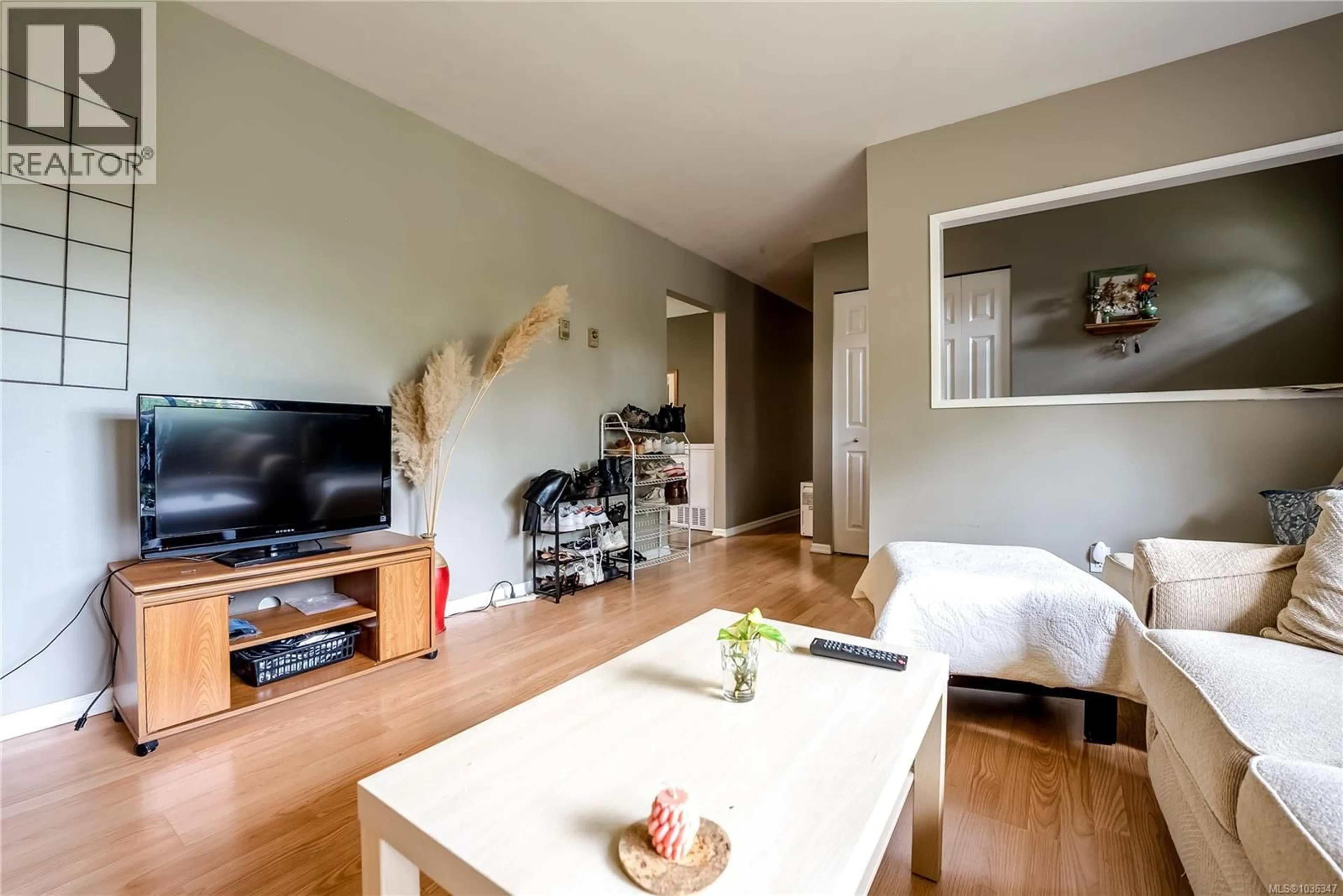 Living room with furniture, wood/laminate floor for 4120 QUADRA STREET, Saanich British Columbia V8X3B9