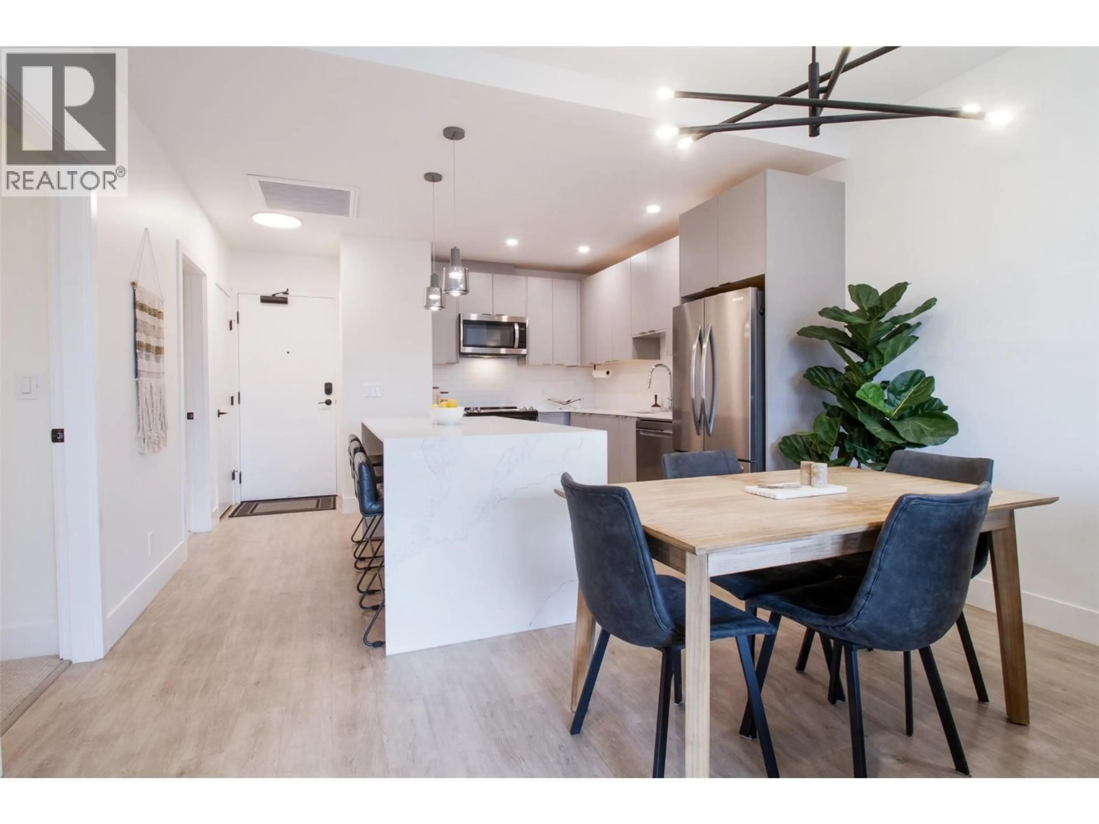 Open concept kitchen, wood/laminate floor for 4403 - 1701 COURSIER AVENUE, Revelstoke British Columbia V0E2S3