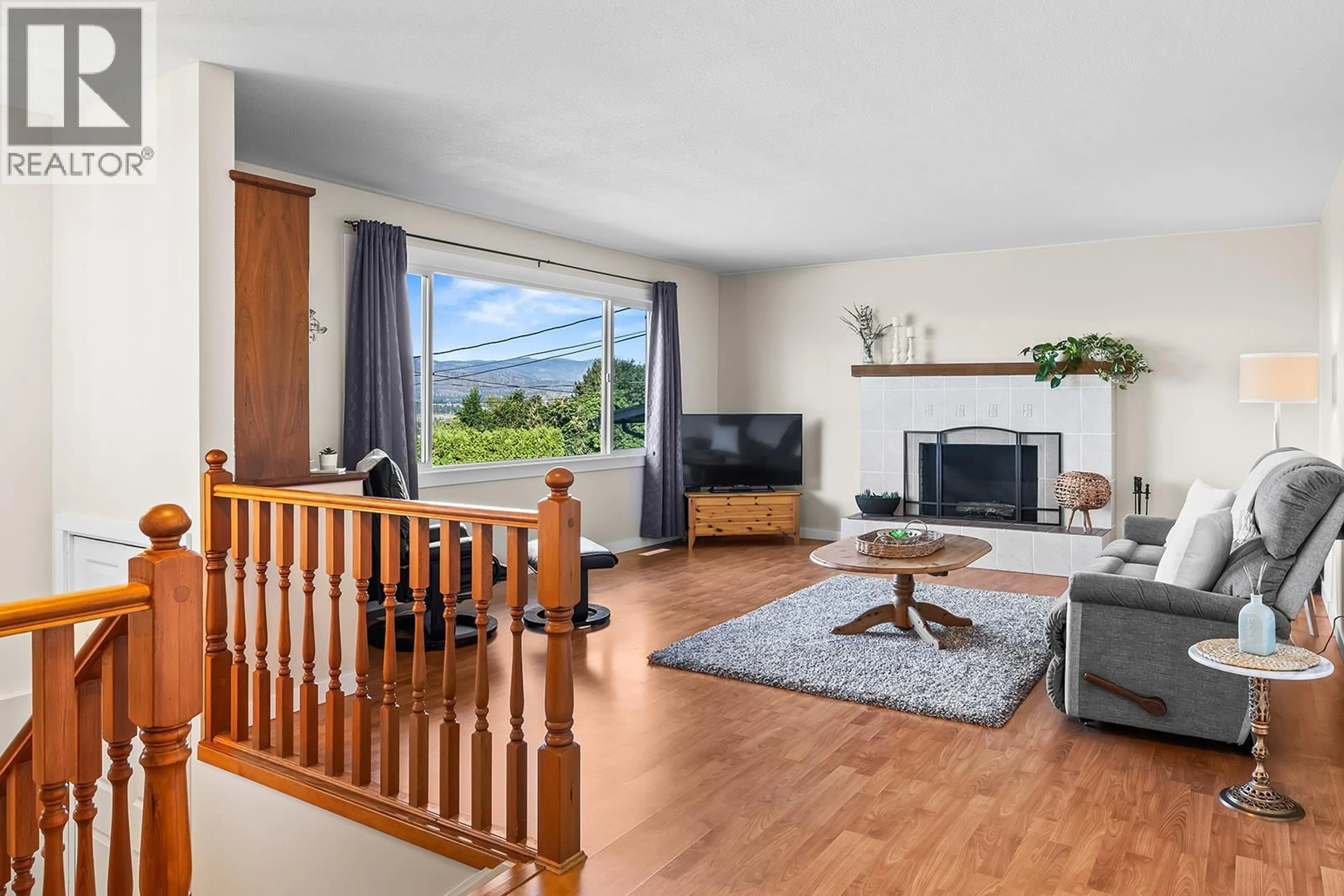 Living room with furniture, wood/laminate floor for 890 MCKENZIE ROAD, Kelowna British Columbia V1X2B3