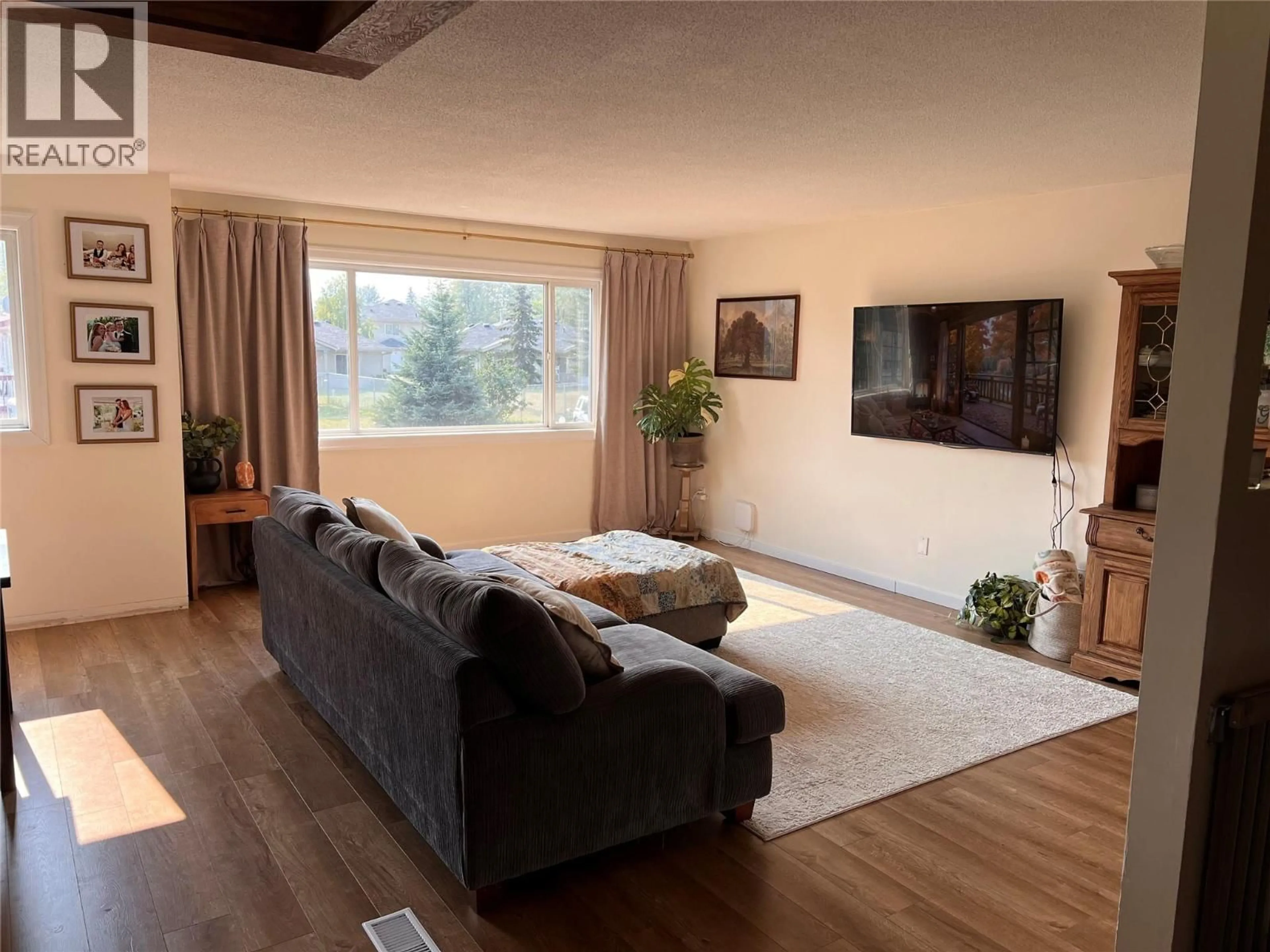 Living room with furniture, wood/laminate floor for 4816 51A AVENUE, Chetwynd British Columbia V0C1J0
