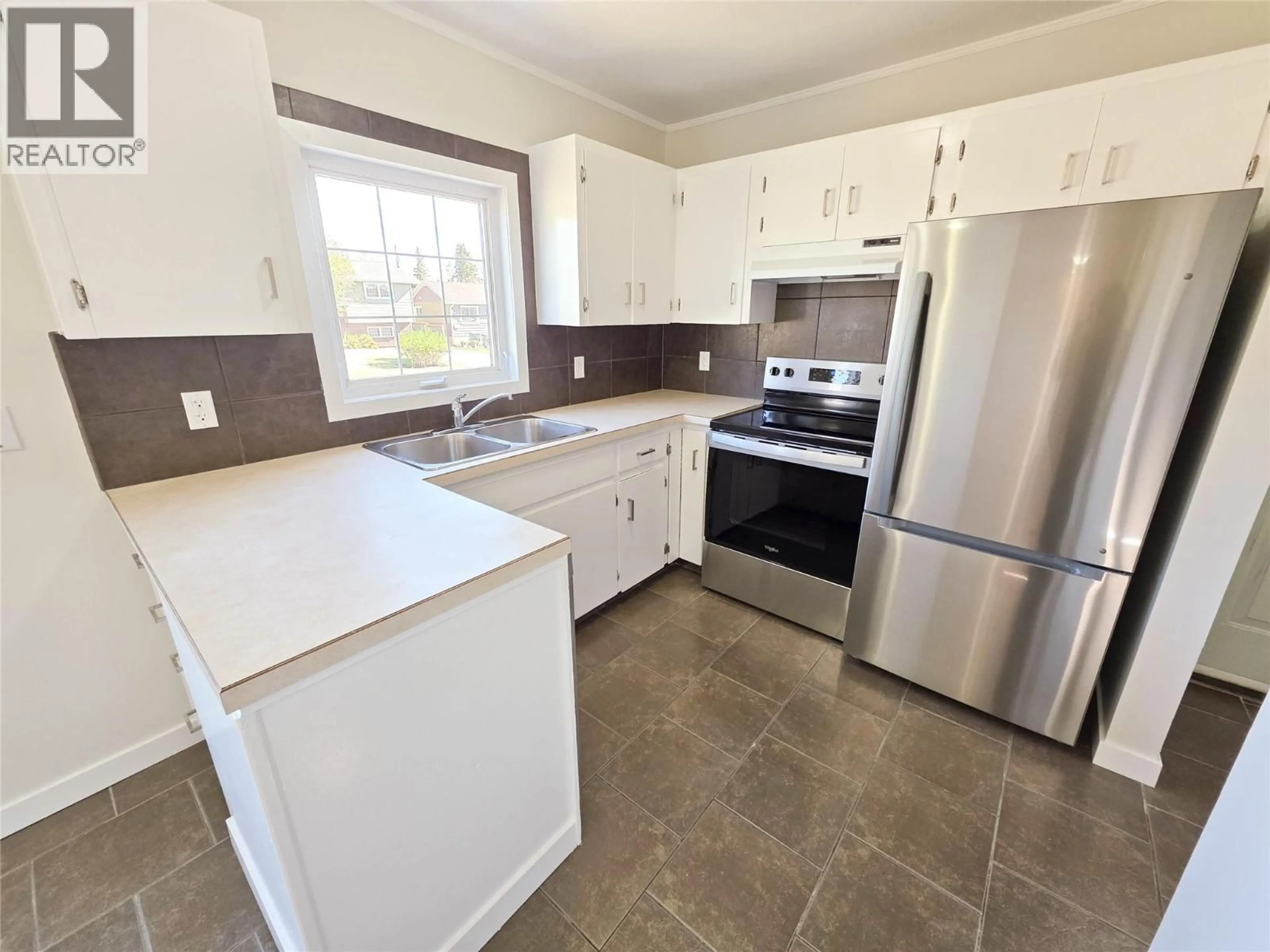 Standard kitchen, ceramic/tile floor for 9705 10 STREET, Dawson Creek British Columbia V1G3S9