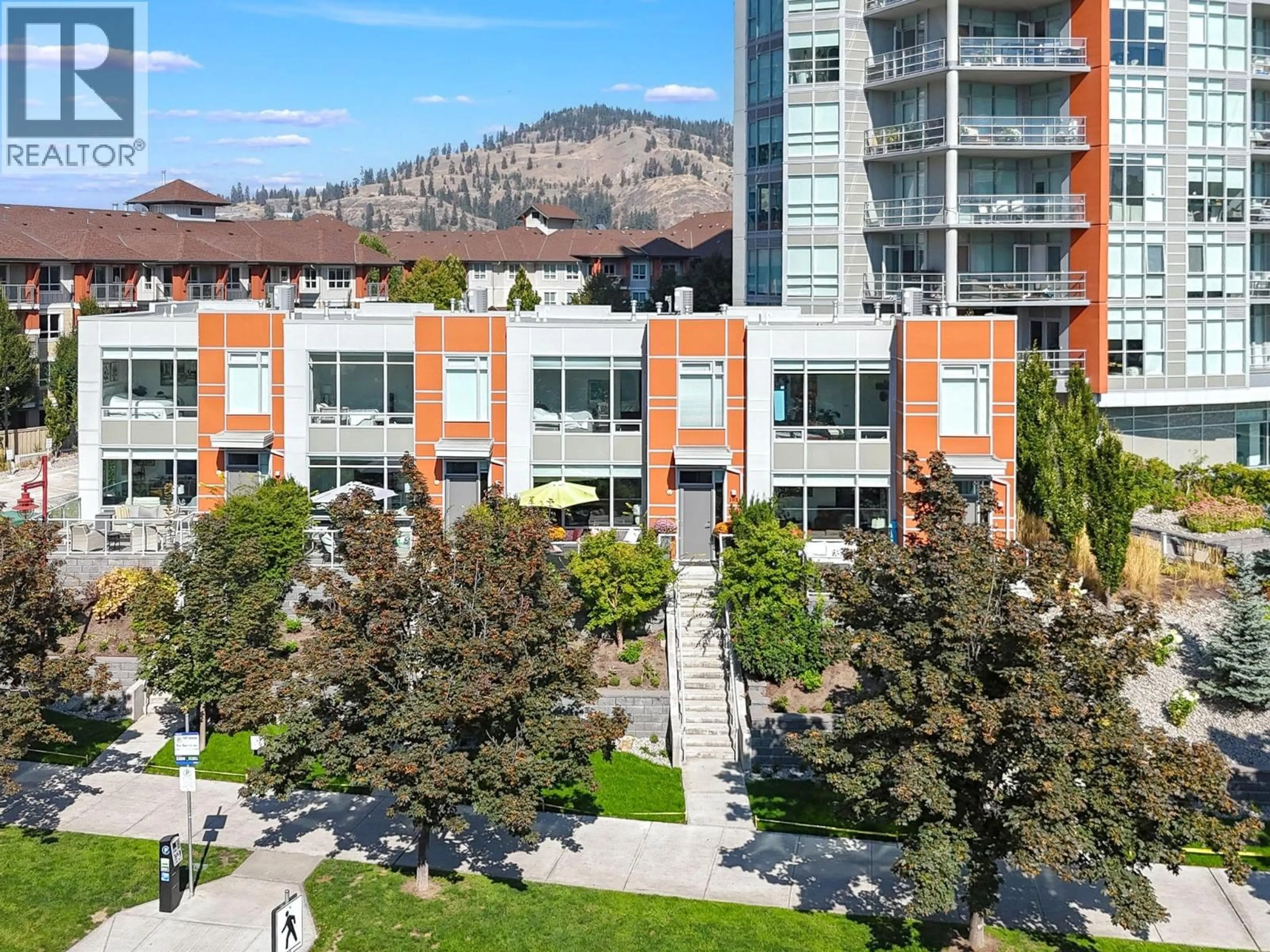 A pic from outside/outdoor area/front of a property/back of a property/a pic from drone, mountain view for 103 - 1151 SUNSET DRIVE, Kelowna British Columbia V1Y0G2