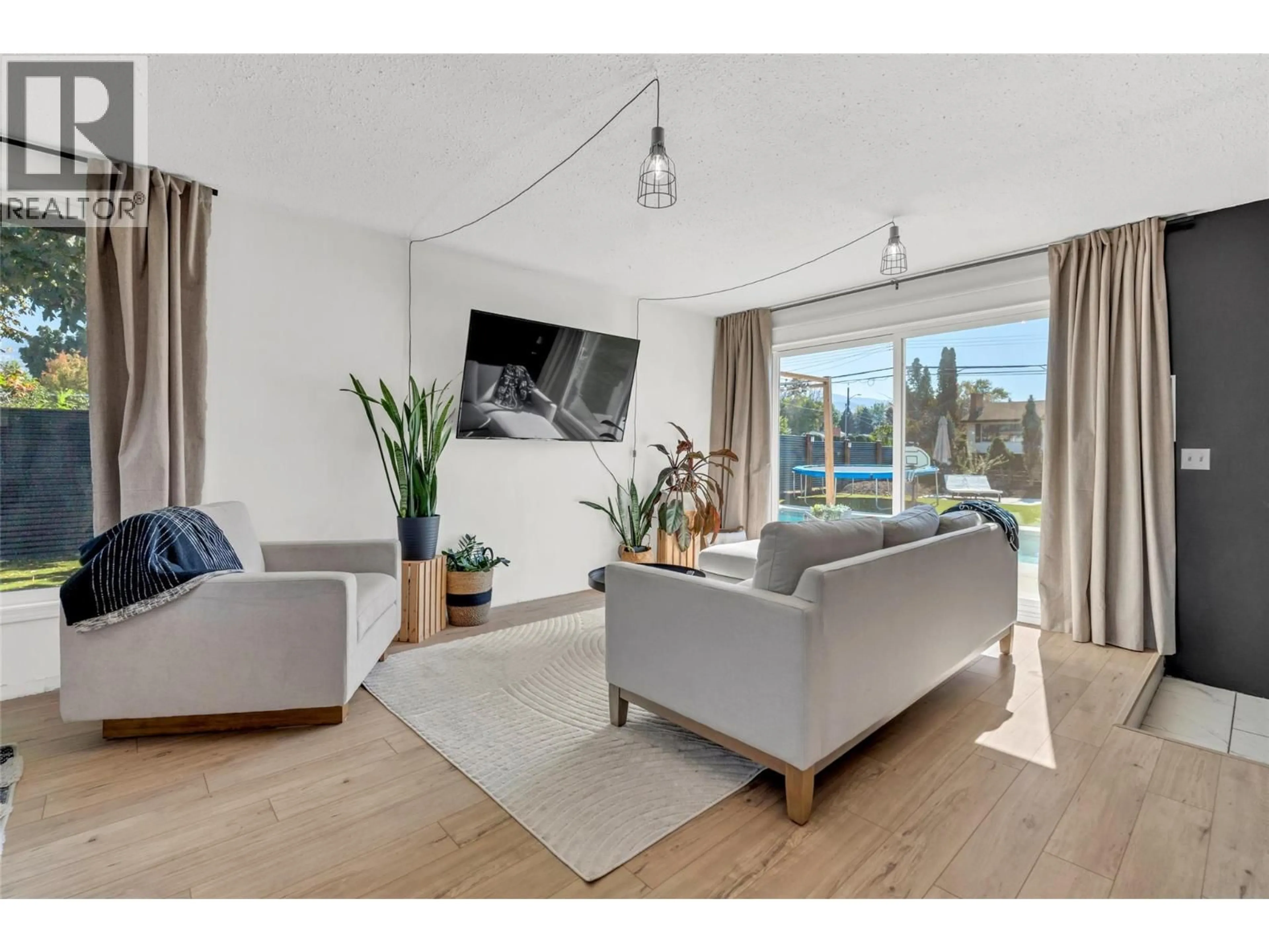 Living room with furniture, wood/laminate floor for 161 HUTH AVENUE, Penticton British Columbia V2A2Z7