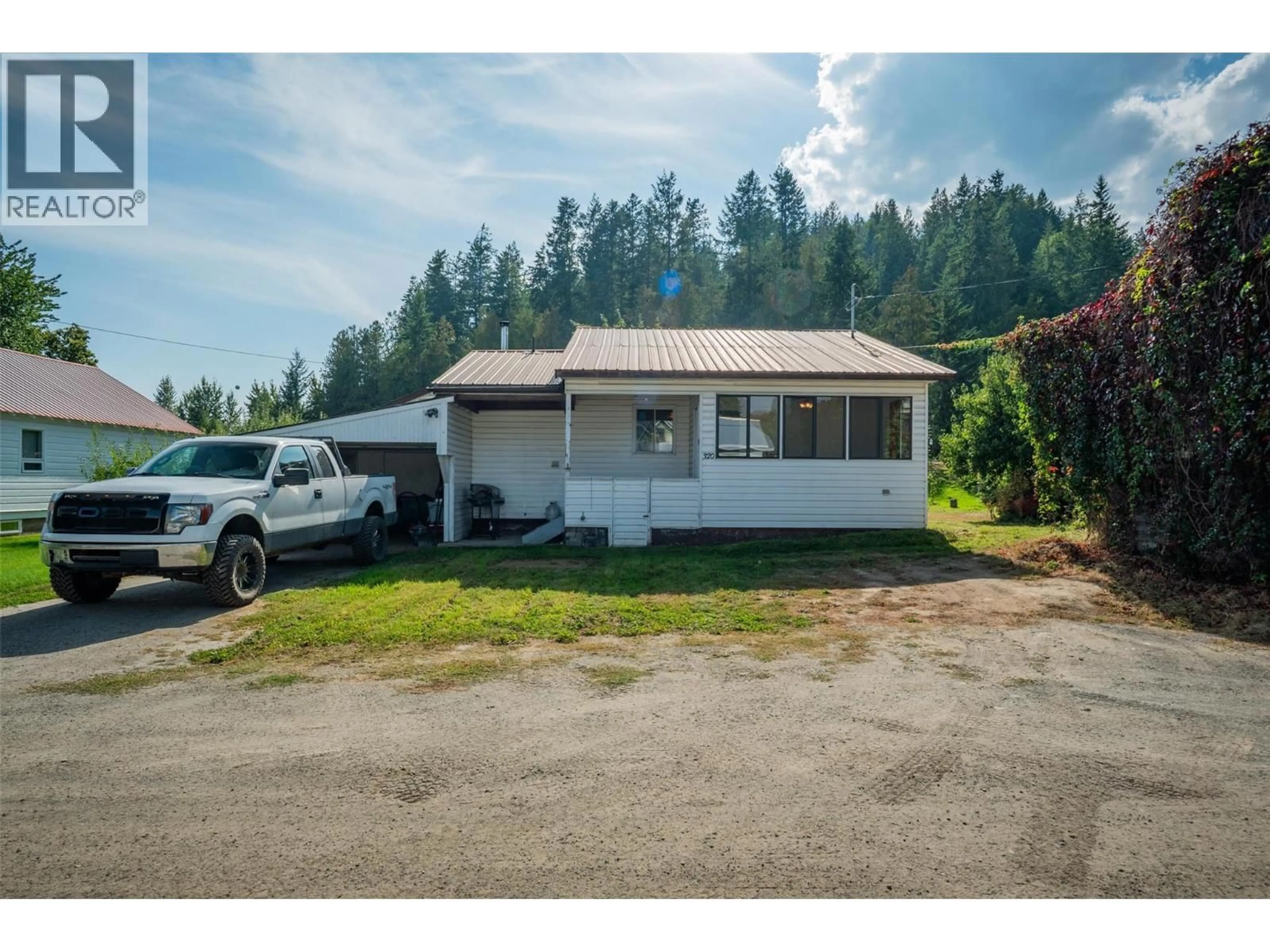 A pic from outside/outdoor area/front of a property/back of a property/a pic from drone, street for 320 RIVER LANE, Kaslo British Columbia V0G1M0