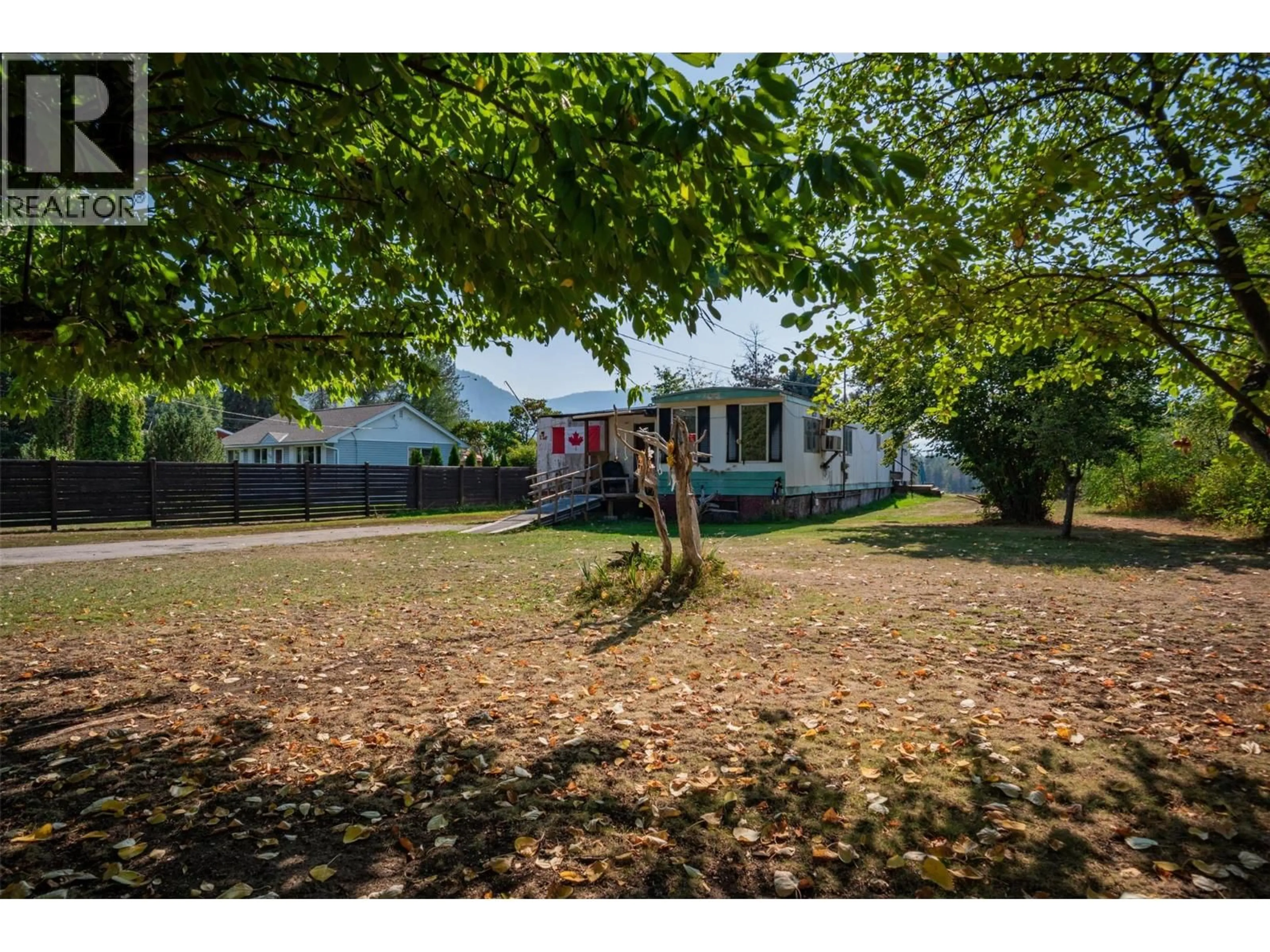 A pic from outside/outdoor area/front of a property/back of a property/a pic from drone, street for 126 100TH STREET, Castlegar British Columbia V1N3C5