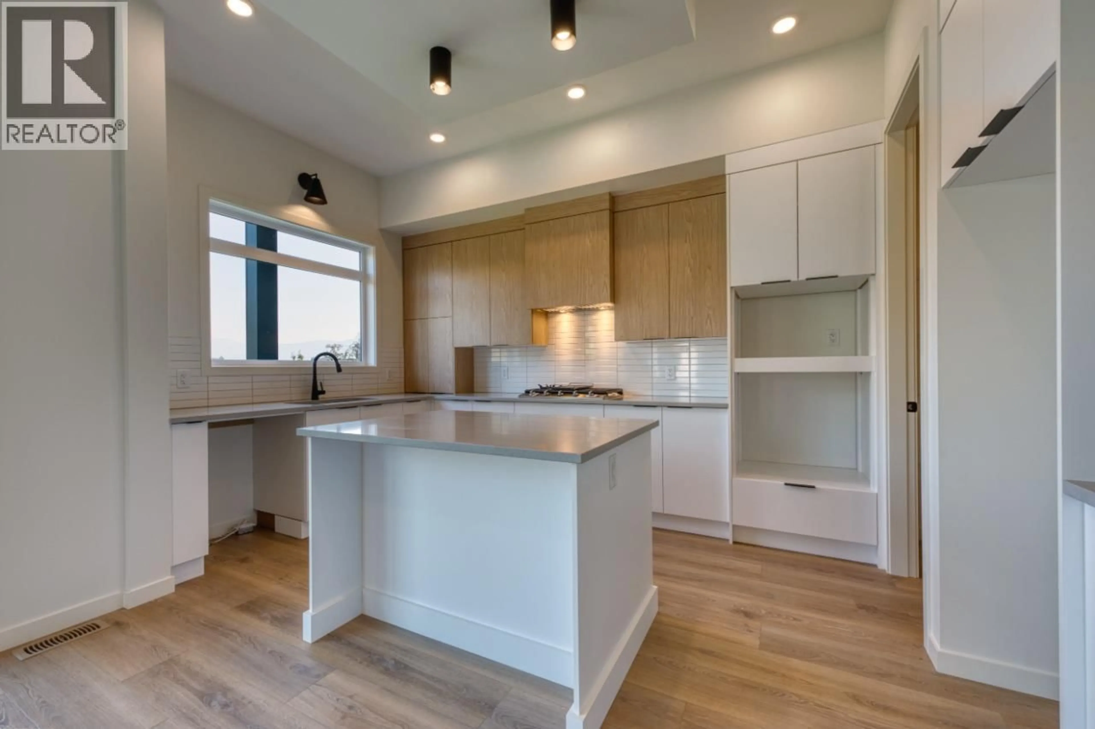 Open concept kitchen, wood/laminate floor for 24 - 7599 KLINGER ROAD, Vernon British Columbia V1H0B2