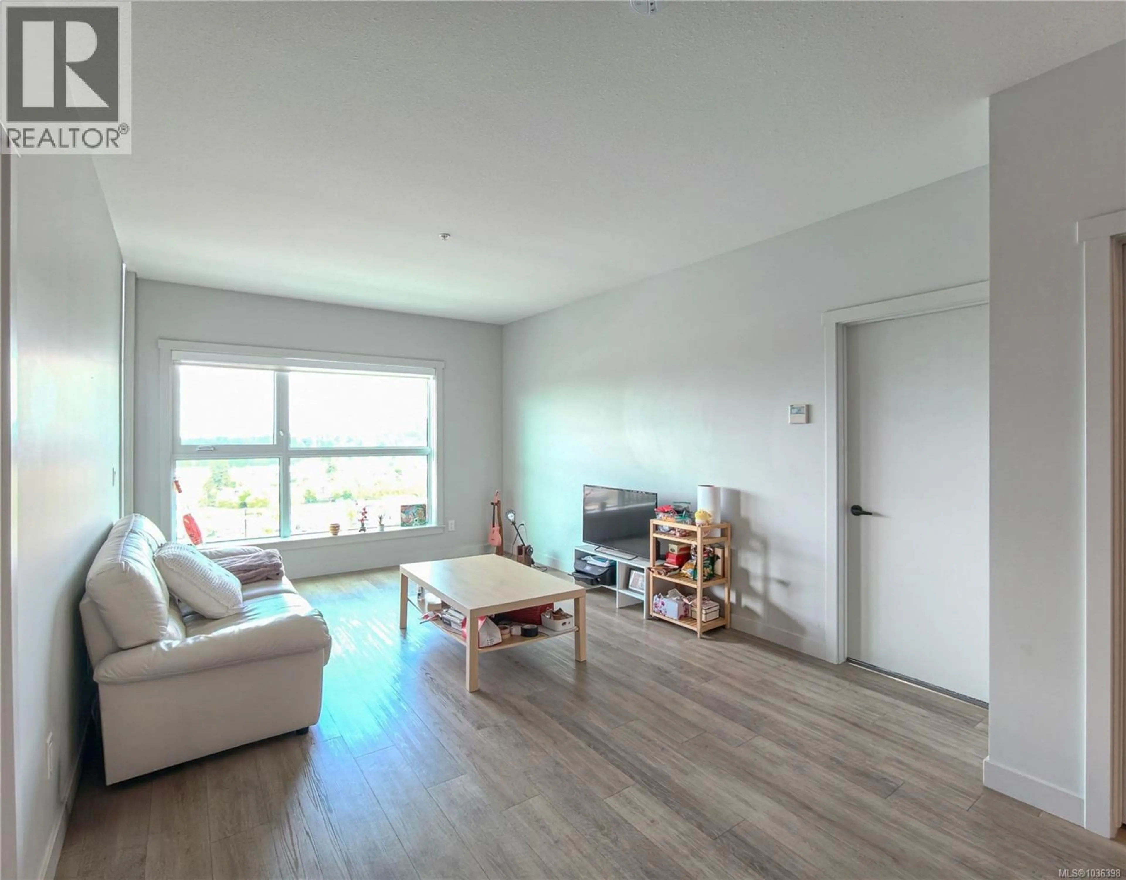 Living room with furniture, wood/laminate floor for 502 - 2465 GATEWAY ROAD, Langford British Columbia V9B6R1