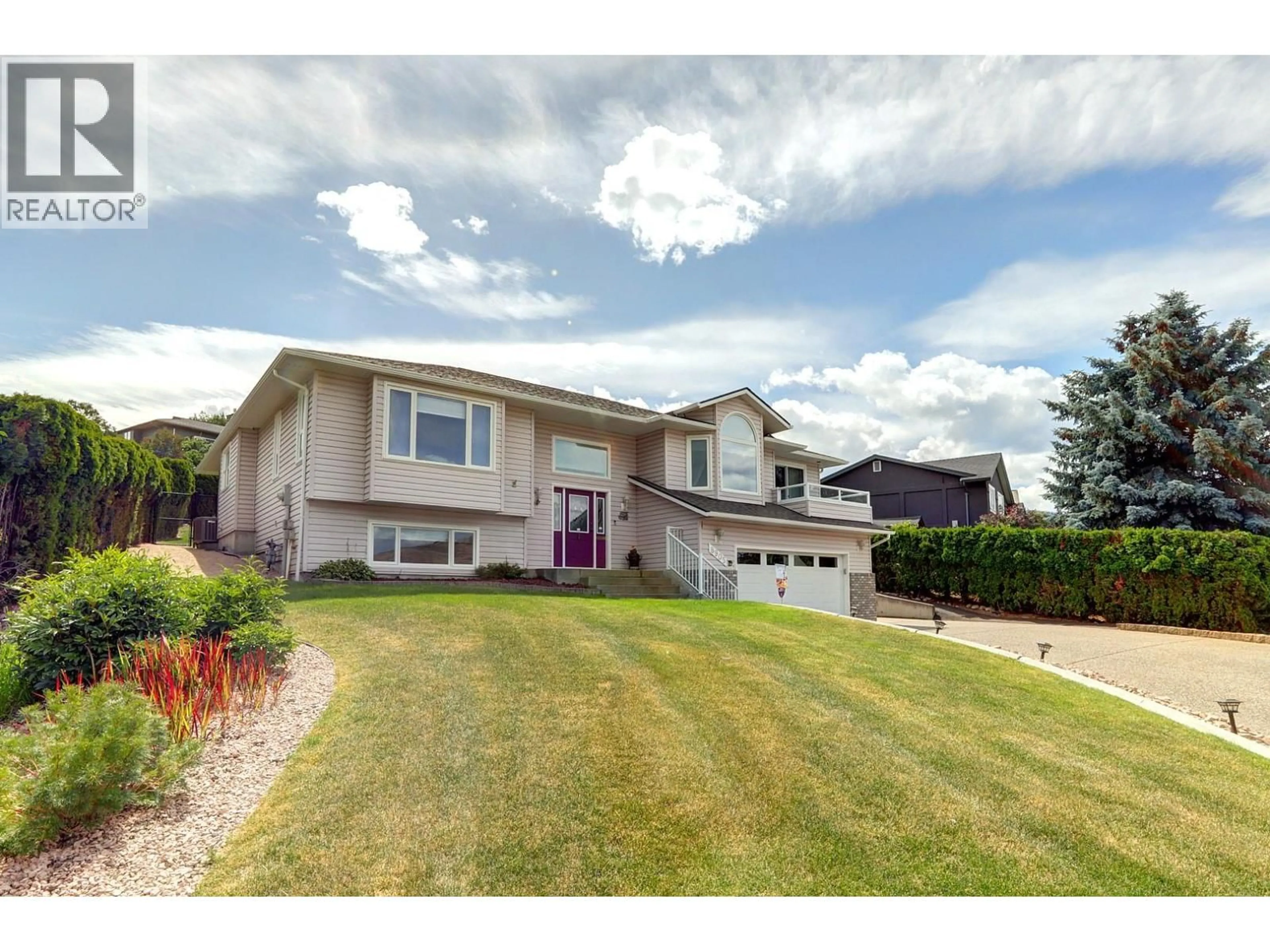 Home with vinyl exterior material, street for 8905 ORCHARD RIDGE DRIVE, Coldstream British Columbia V1B1Z7