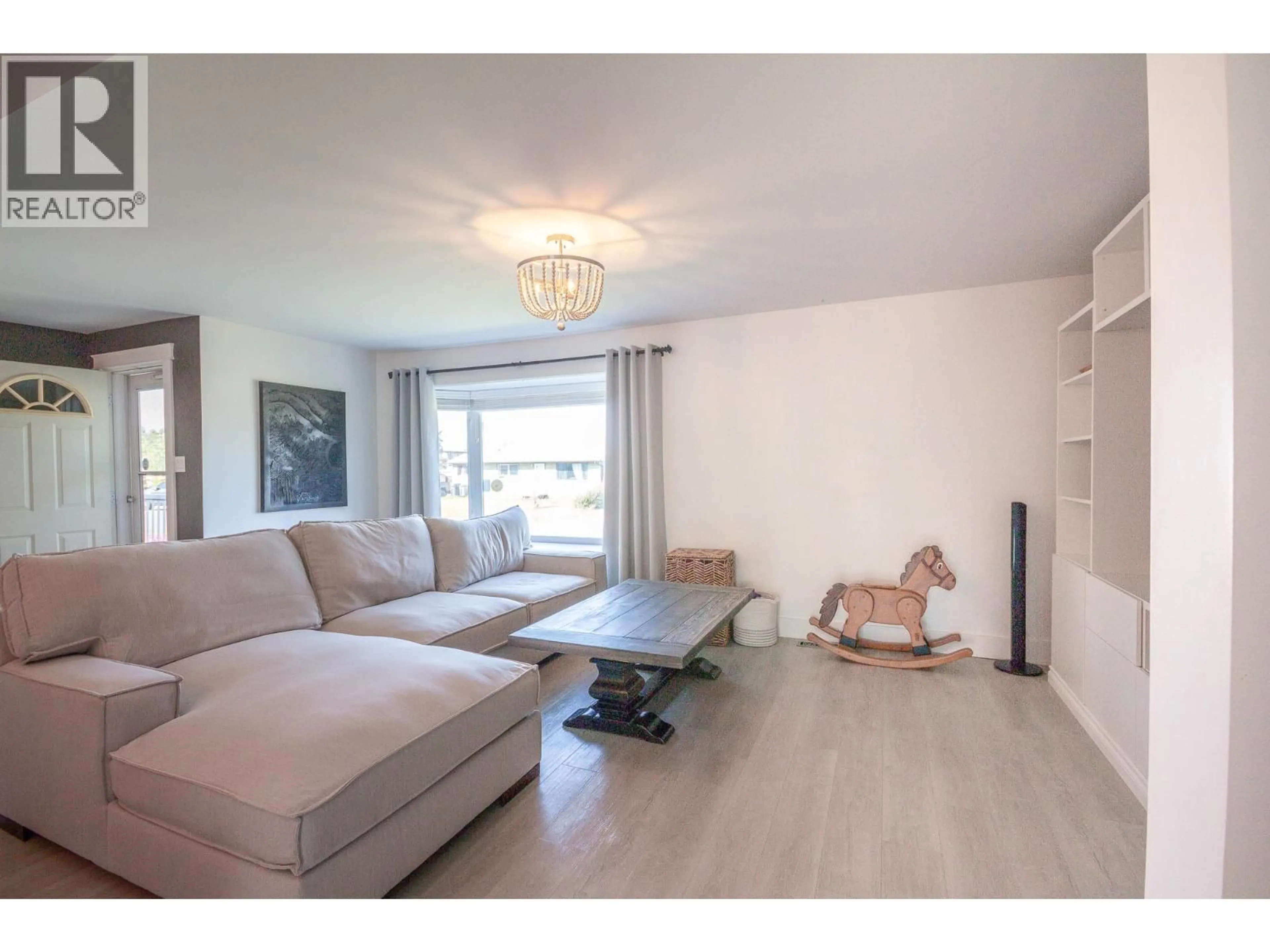 Living room with furniture, wood/laminate floor for 1209 113 AVENUE, Dawson Creek British Columbia V1G2Y9