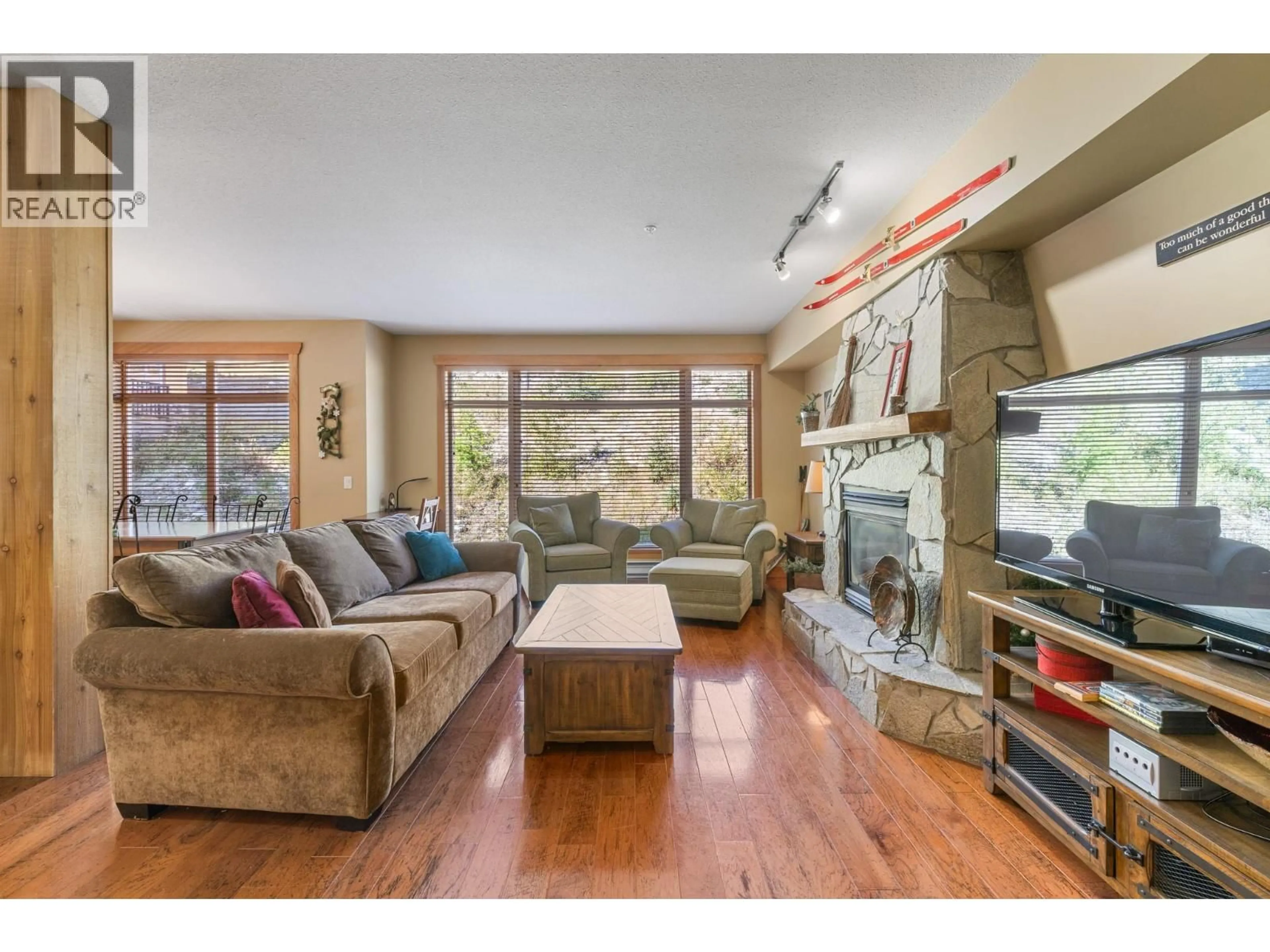 Living room with furniture, wood/laminate floor for 206 - 315 WHITEHORSE LANE, Big White British Columbia V1P1P3
