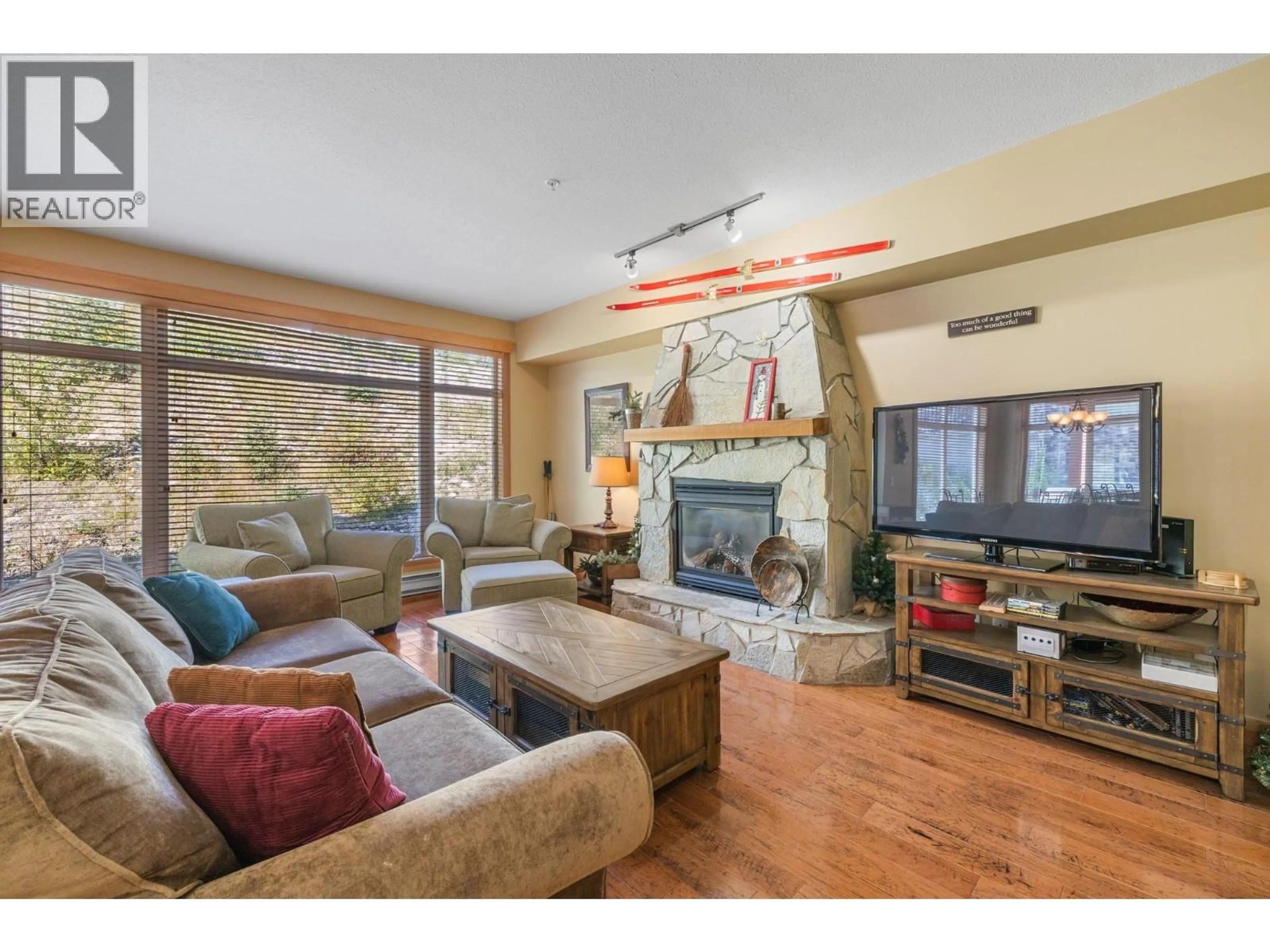 Living room with furniture, wood/laminate floor for 206 - 315 WHITEHORSE LANE, Big White British Columbia V1P1P3