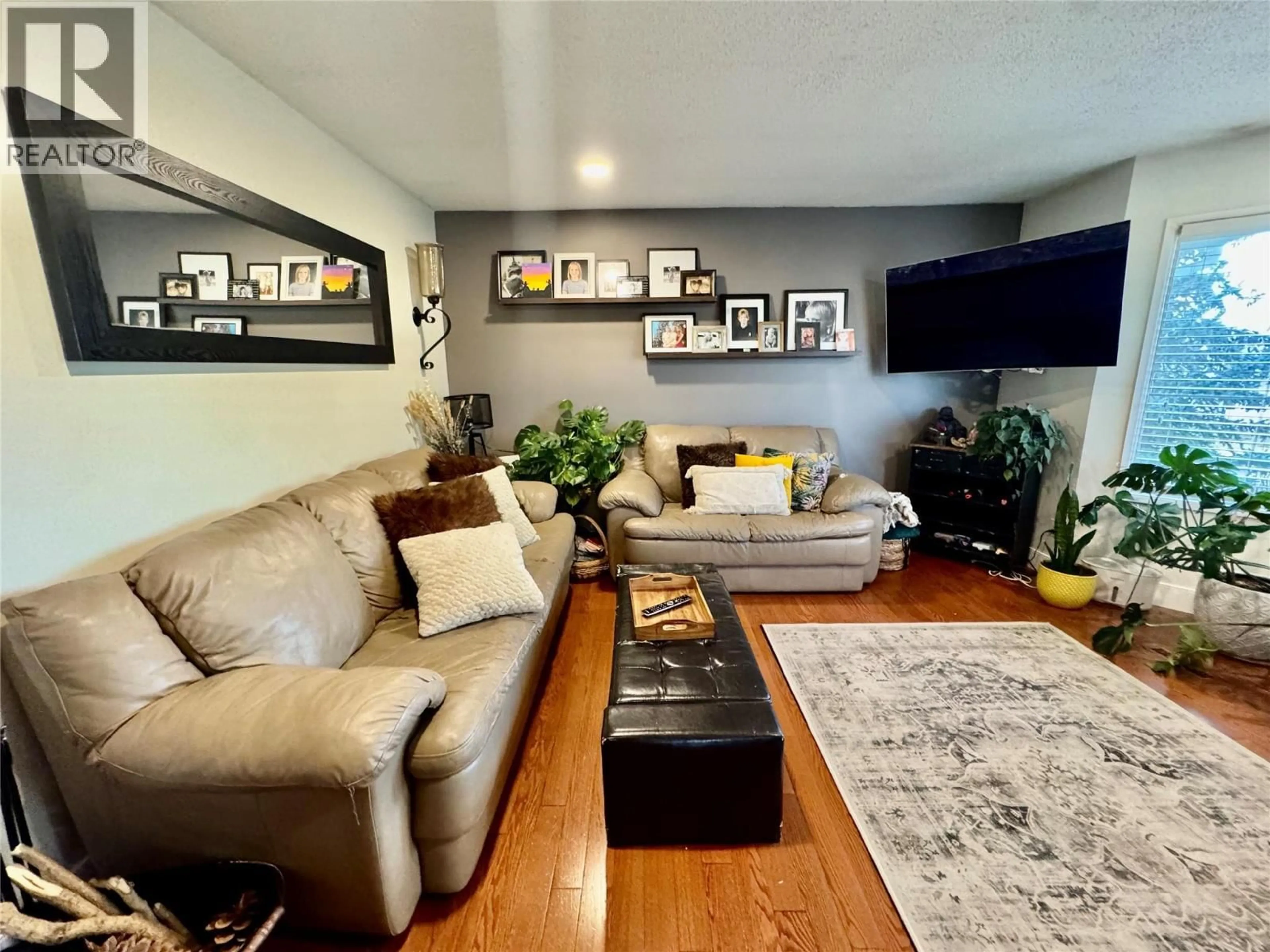 Living room with furniture, wood/laminate floor for 1715 CEDARWOOD COURT, Dawson Creek British Columbia V1G4N4