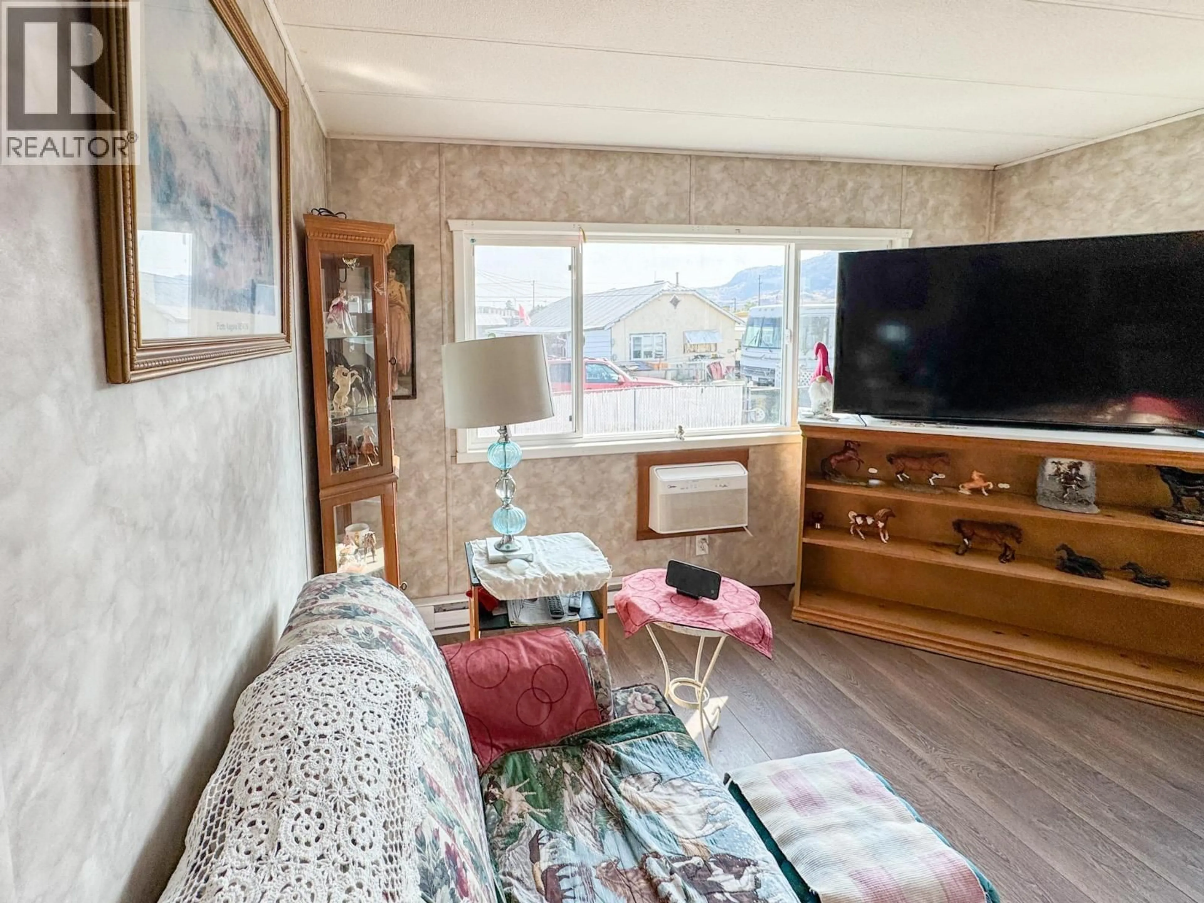 Living room with furniture, wood/laminate floor for 4 - 7614 97TH STREET, Osoyoos British Columbia V0H1V5
