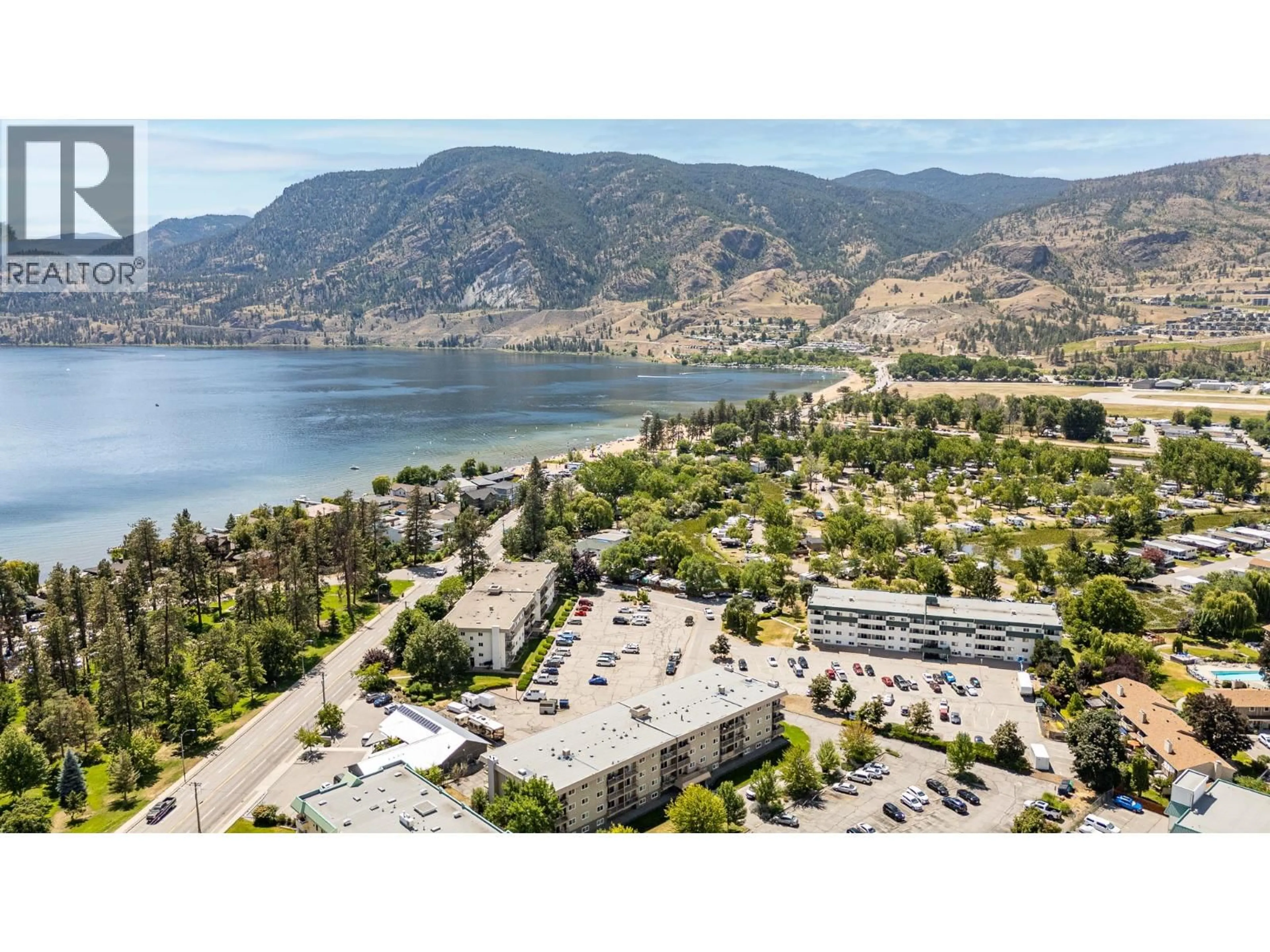 A pic from outside/outdoor area/front of a property/back of a property/a pic from drone, mountain view for 306 - 130 SKAHA PLACE, Penticton British Columbia V2A7J6