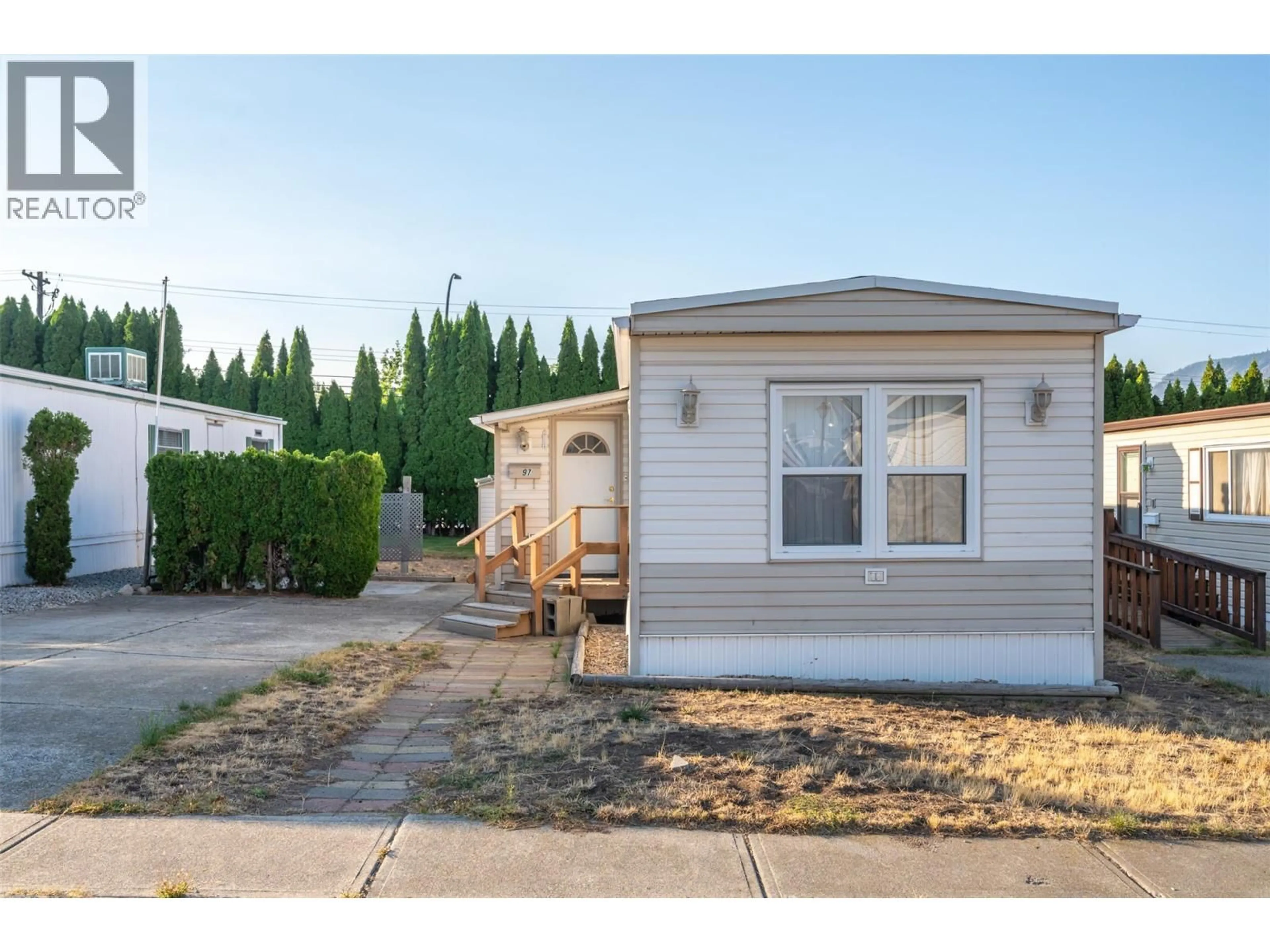 Home with vinyl exterior material, street for 97 - 98 OKANAGAN AVENUE EAST, Penticton British Columbia V2A3J5