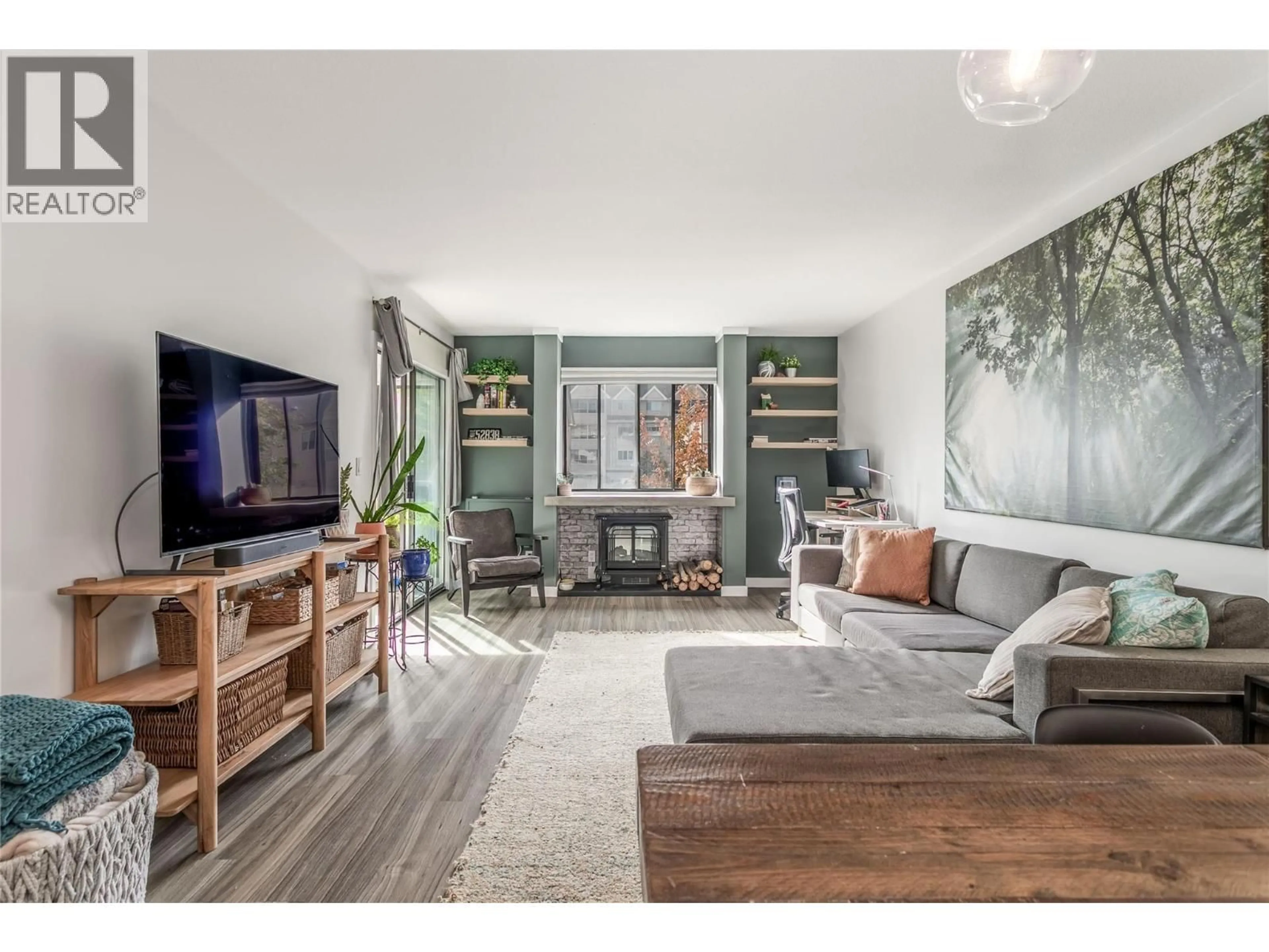 Living room with furniture, wood/laminate floor for 110 - 1075 BERNARD AVENUE, Kelowna British Columbia V1Y6P7