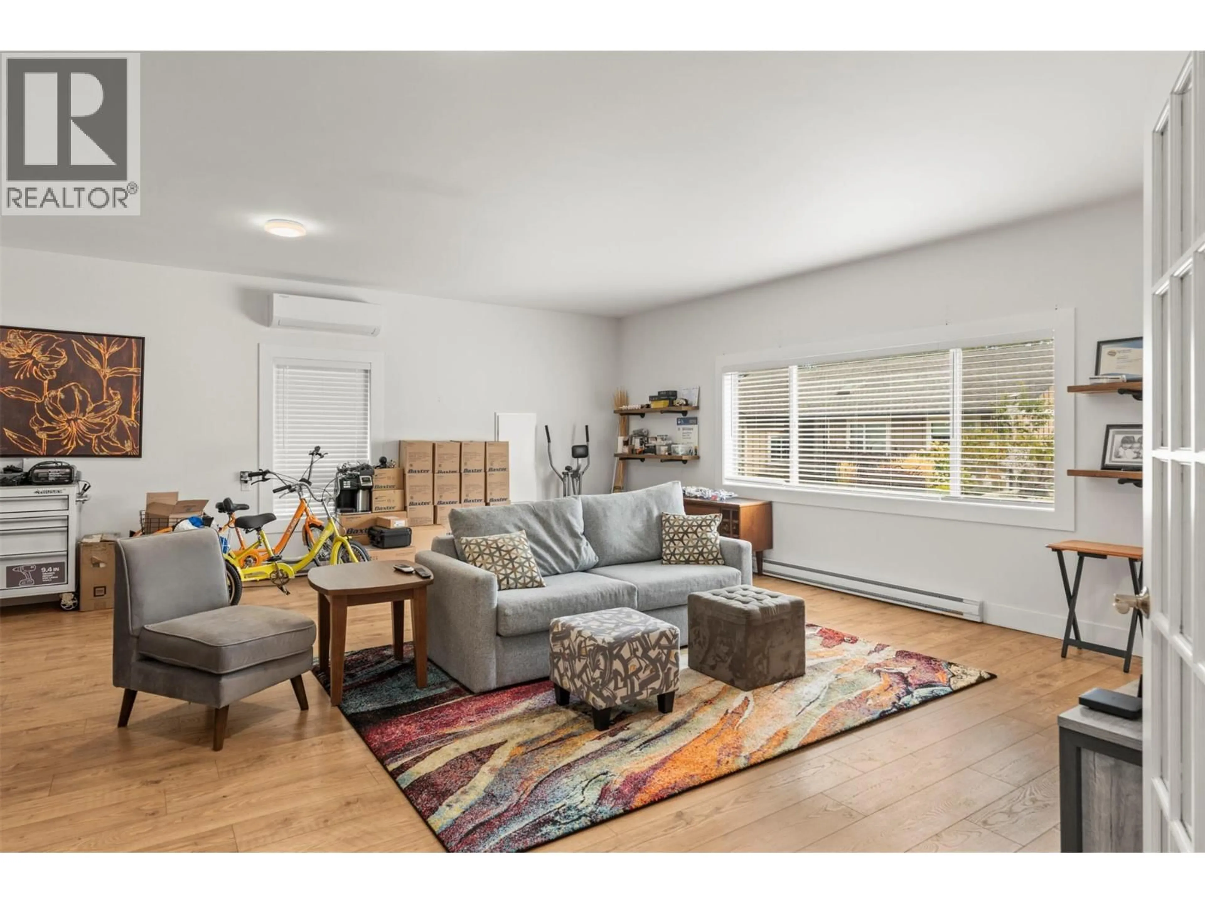 Living room with furniture, wood/laminate floor for 205 FALCON AVENUE, Vernon British Columbia V1H2A1
