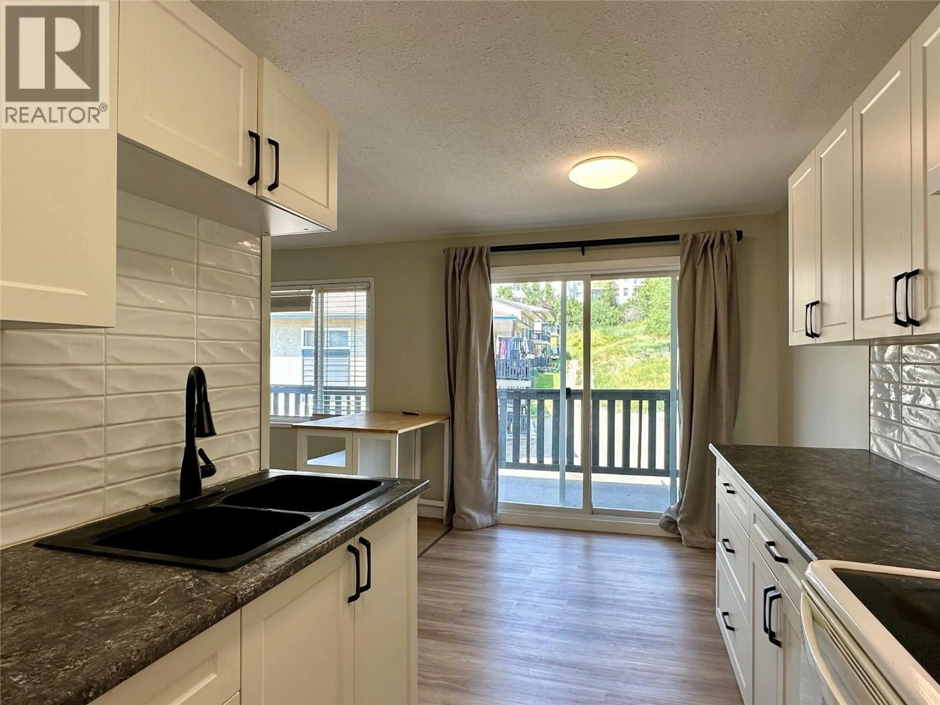 Open concept kitchen, wood/laminate floor for 215 - 3505 38 STREET, Vernon British Columbia V1T6X1