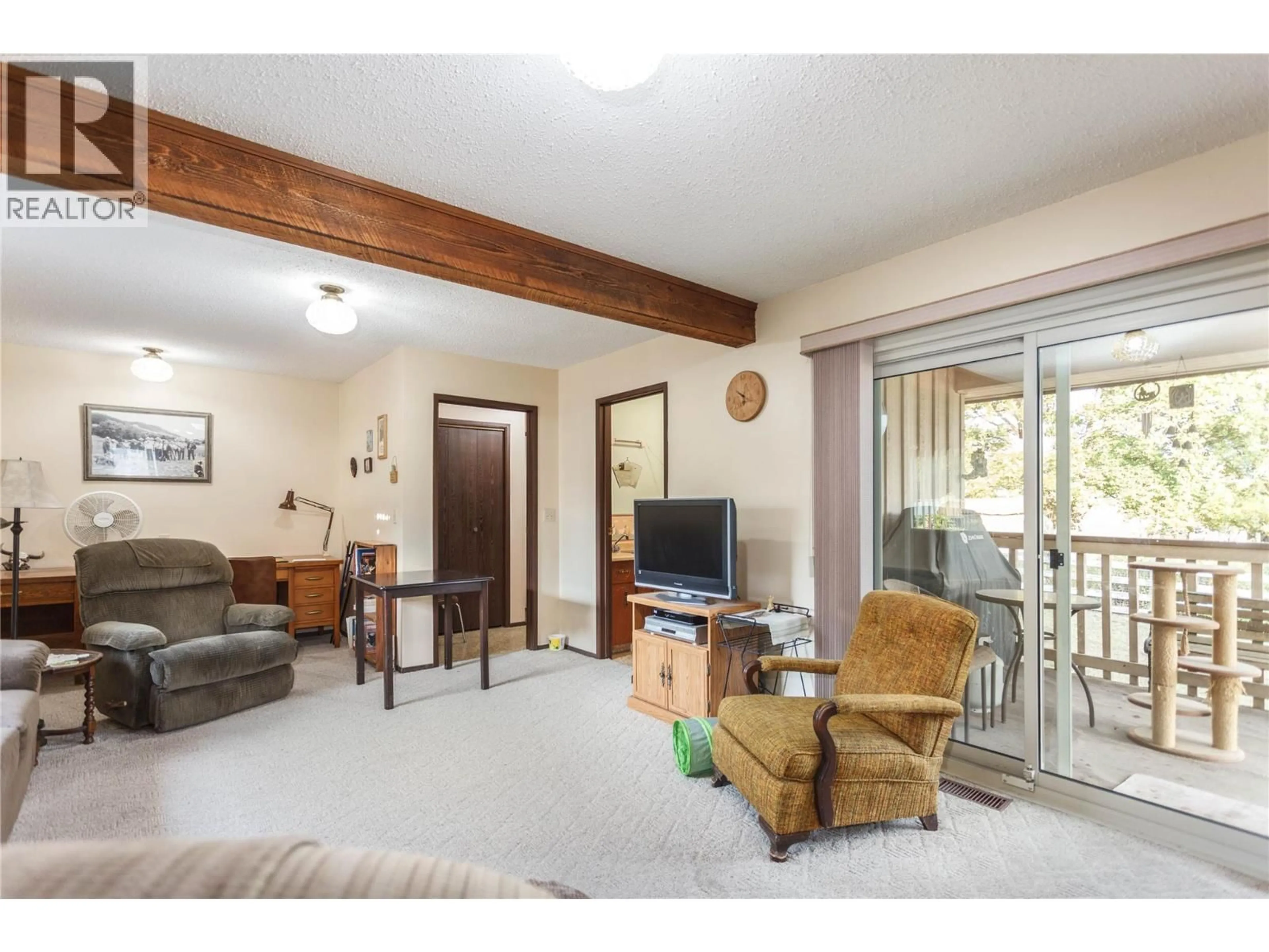 Living room with furniture, wood/laminate floor for 6958 BUCHANAN ROAD, Coldstream British Columbia B1B3C5
