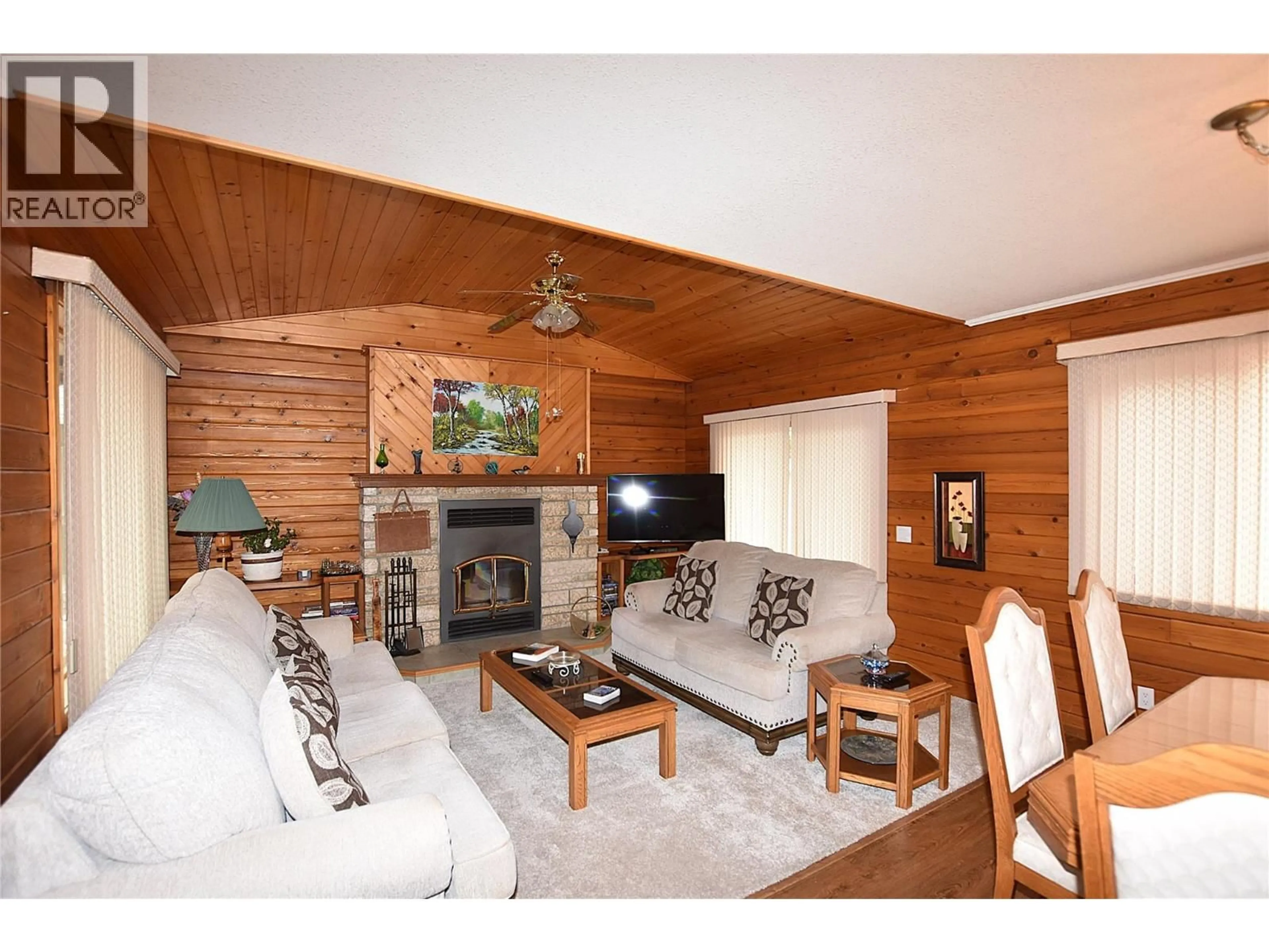 Living room with furniture, wood/laminate floor for 65 ELK STREET, Vernon British Columbia V1H2A1