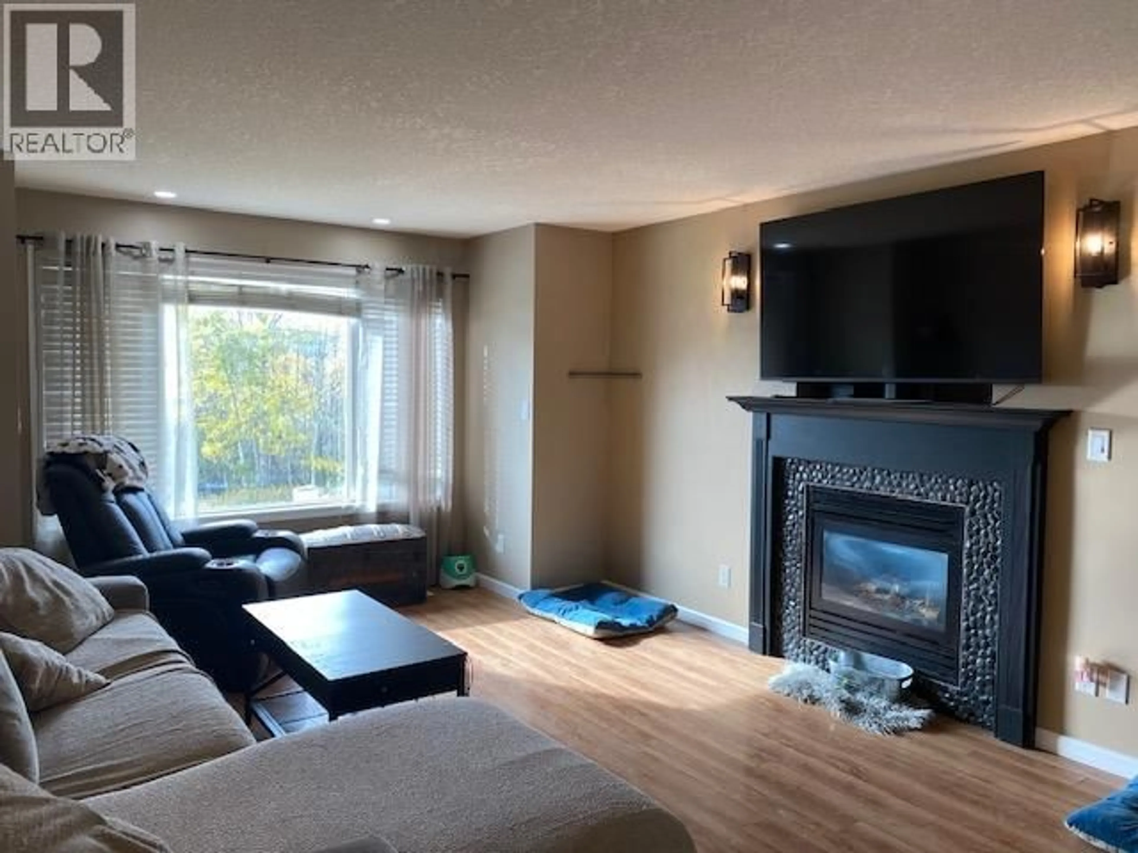 Living room with furniture, wood/laminate floor for 5404 HILLSIDE AVENUE, Chetwynd British Columbia V0C1J0