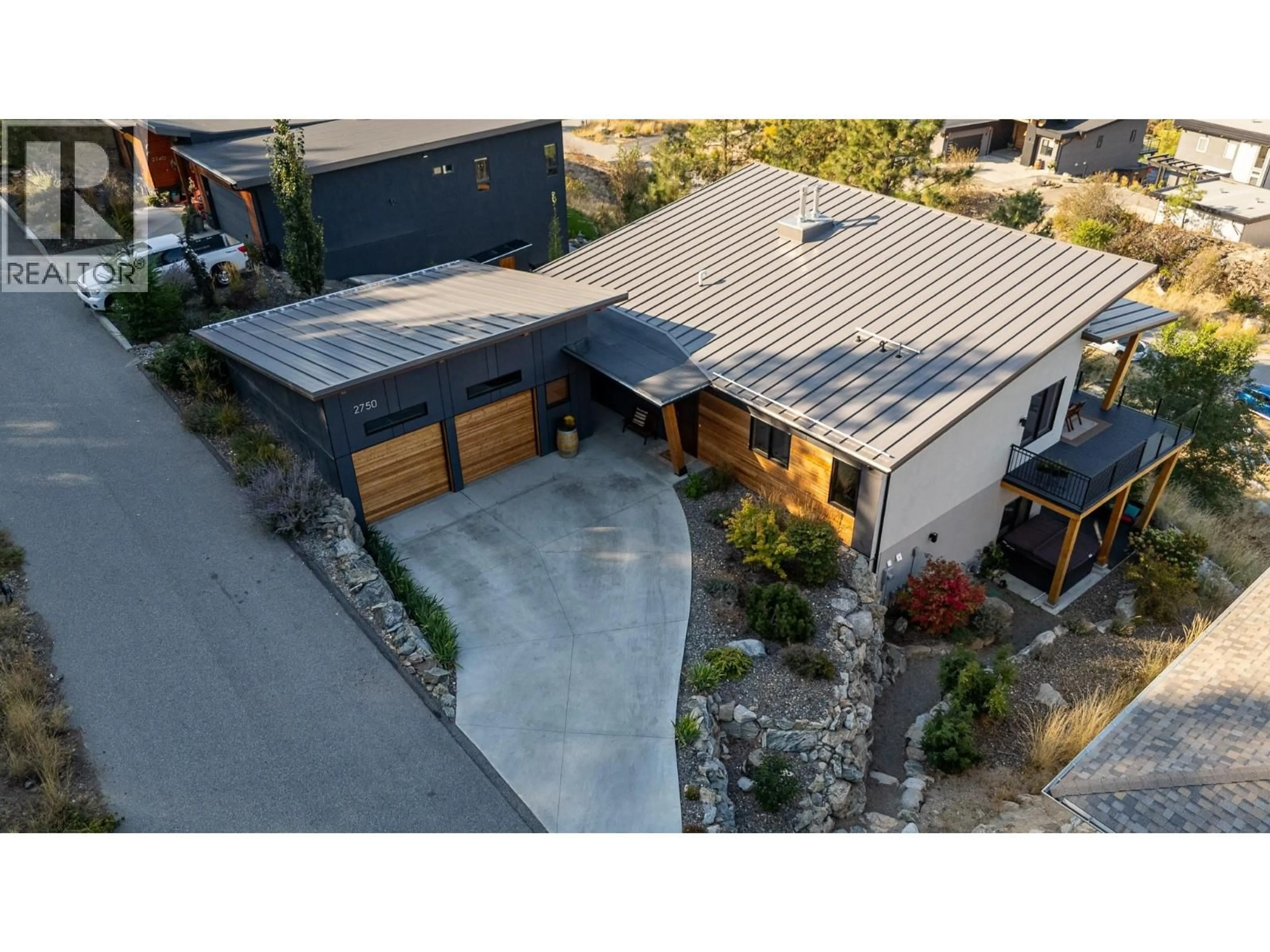 A pic from outside/outdoor area/front of a property/back of a property/a pic from drone, street for 2750 WORKMAN PLACE, Naramata British Columbia V0H1N1