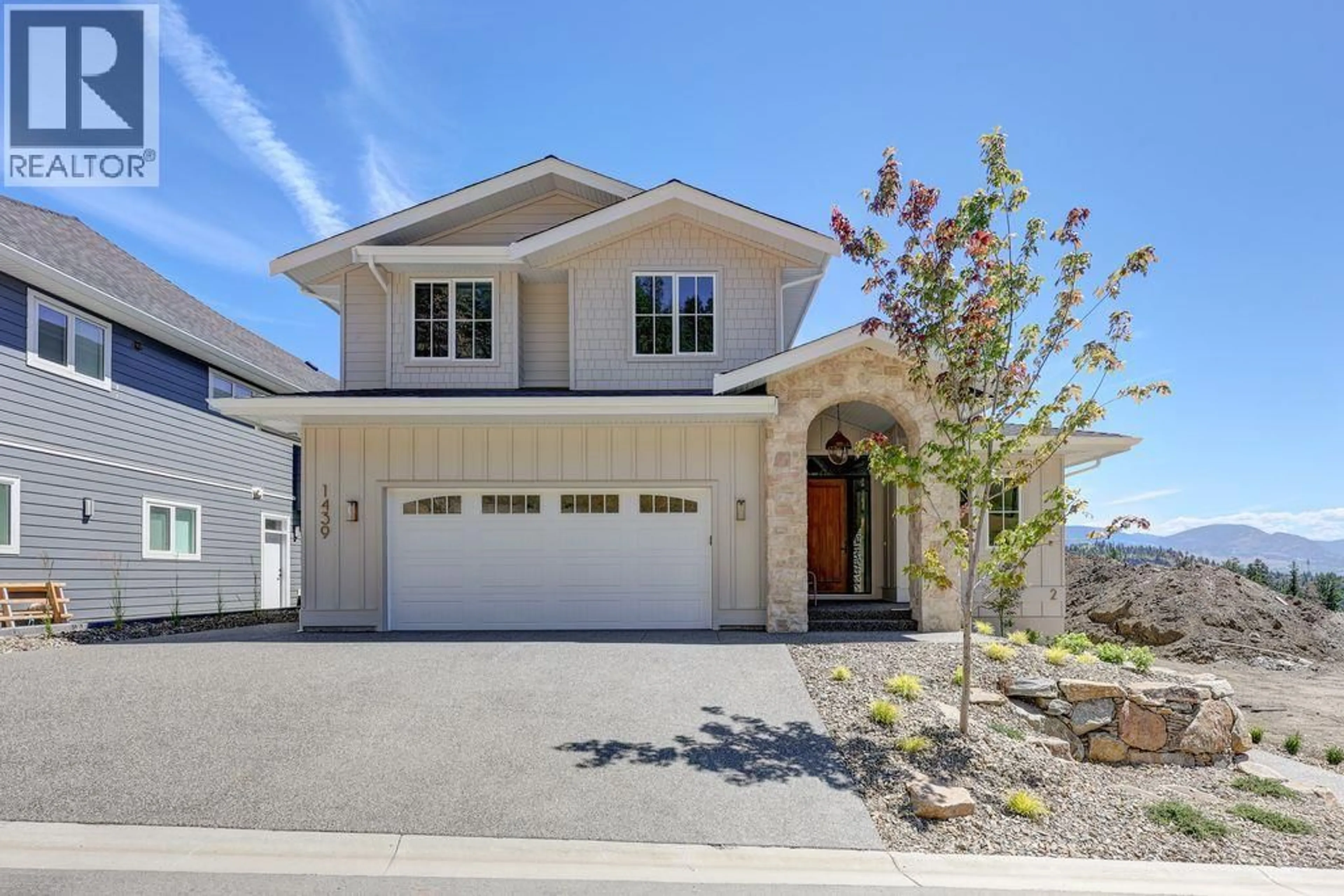 Home with vinyl exterior material, street for 1439 WHISTLING PINE PLACE, Kelowna British Columbia V1V2C6