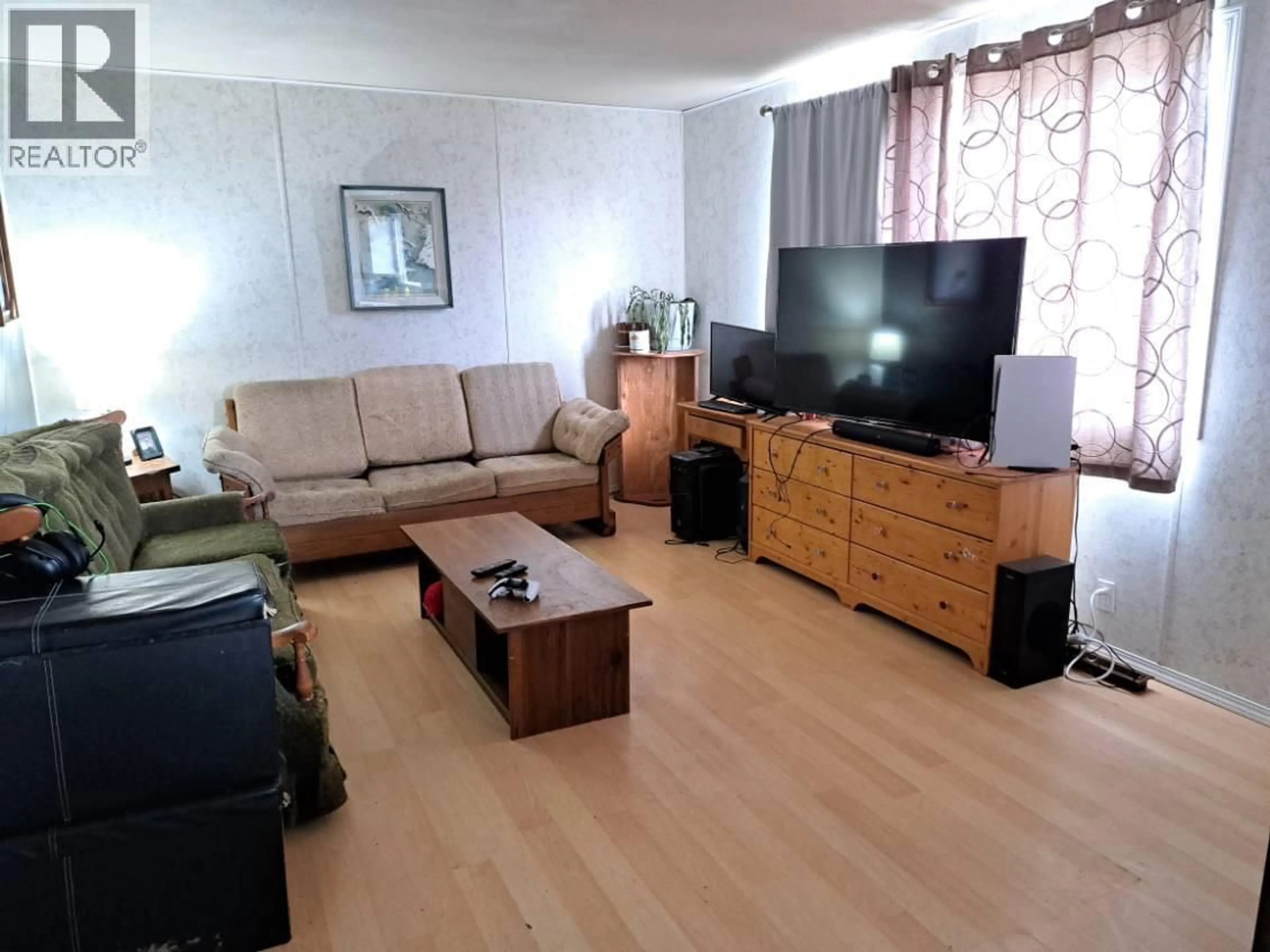 Living room with furniture, wood/laminate floor for 11313 13 STREET, Dawson Creek British Columbia V1G3X1