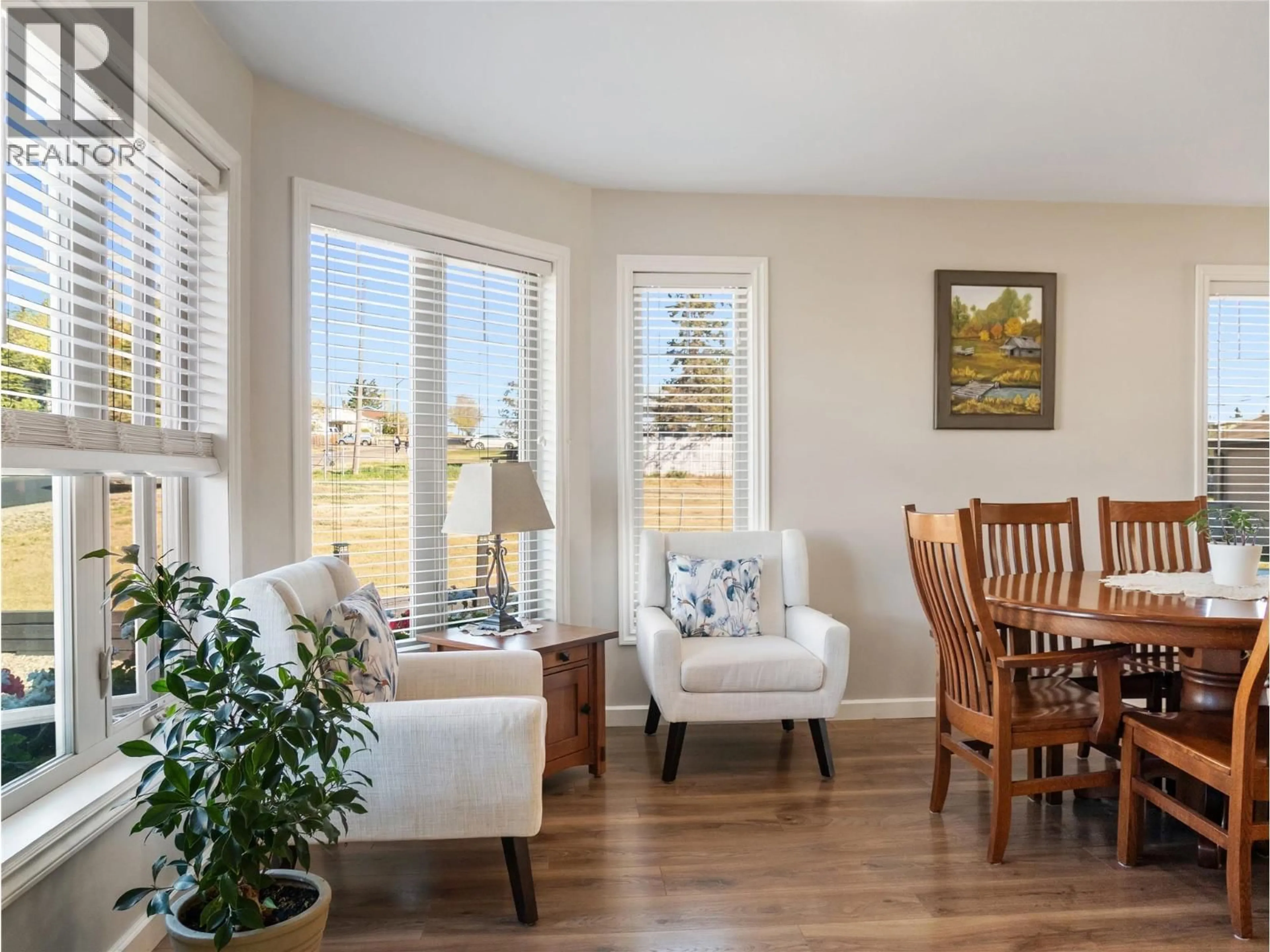 Living room with furniture, wood/laminate floor for 705 97A AVENUE, Dawson Creek British Columbia V1G1R2