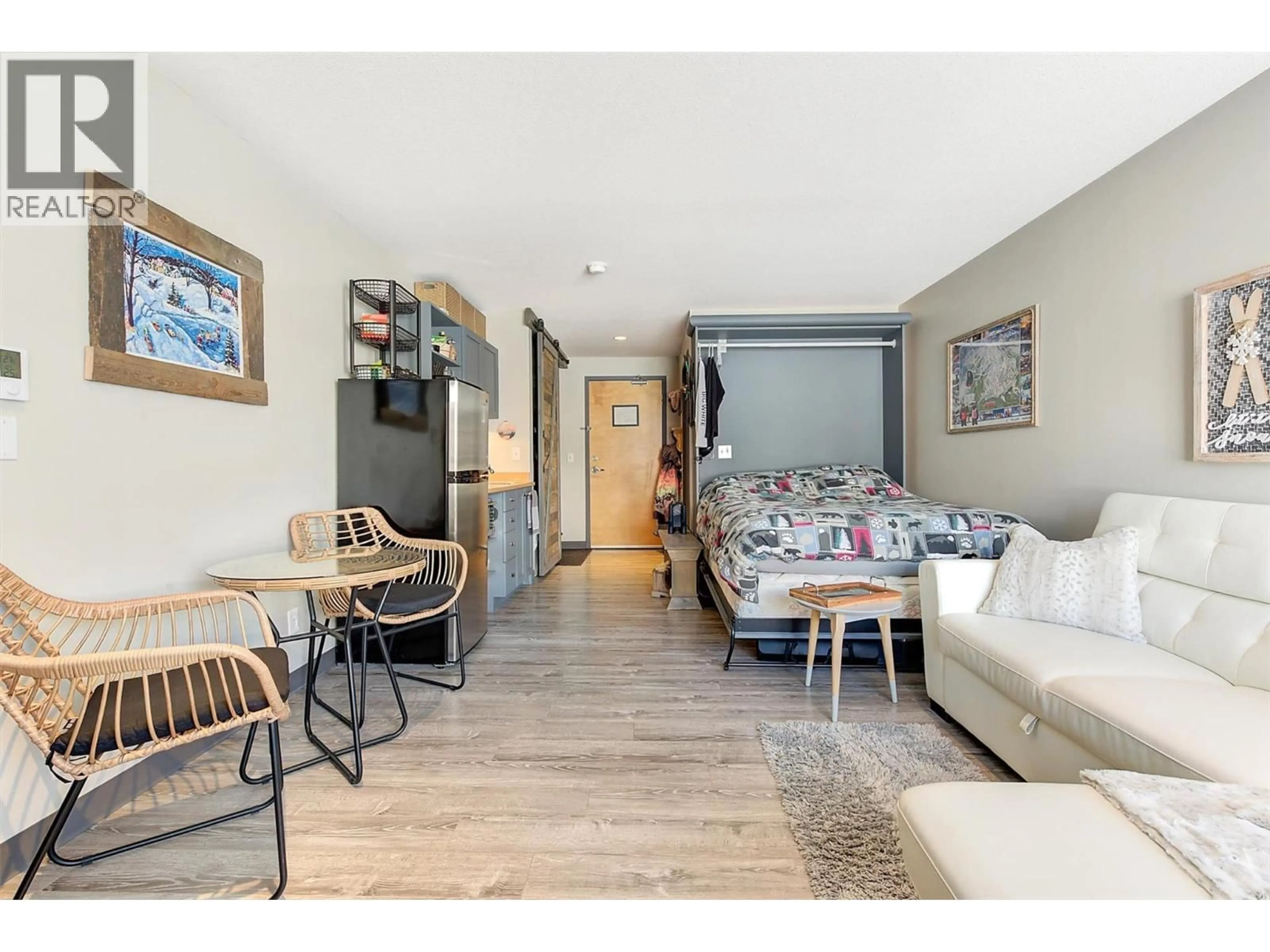 Living room with furniture, wood/laminate floor for 335 - 5340 BIG WHITE ROAD, Big White British Columbia V1P1P3