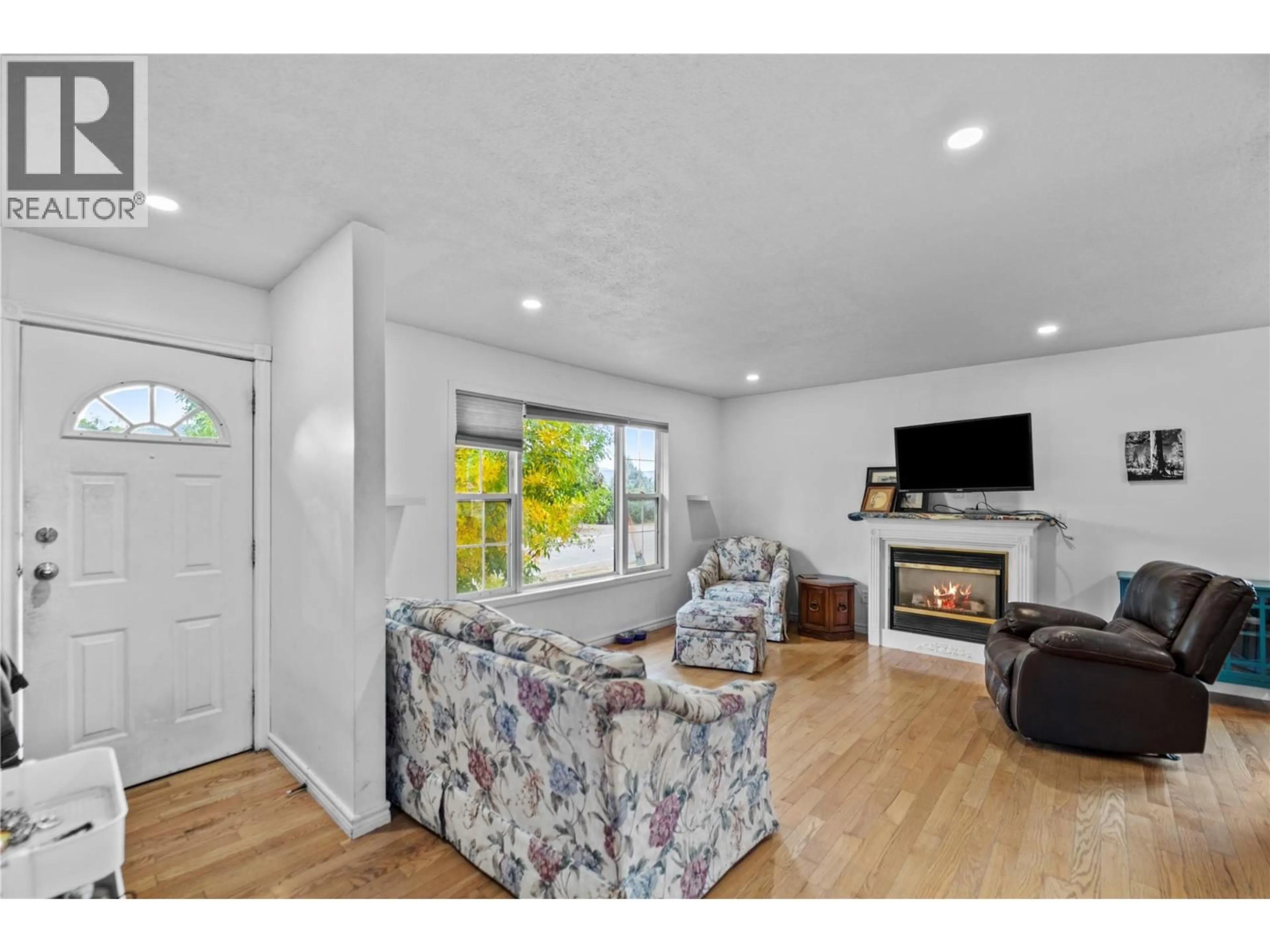Living room with furniture, wood/laminate floor for 1810 ARMSTRONG STREET, Merritt British Columbia V1K0B1