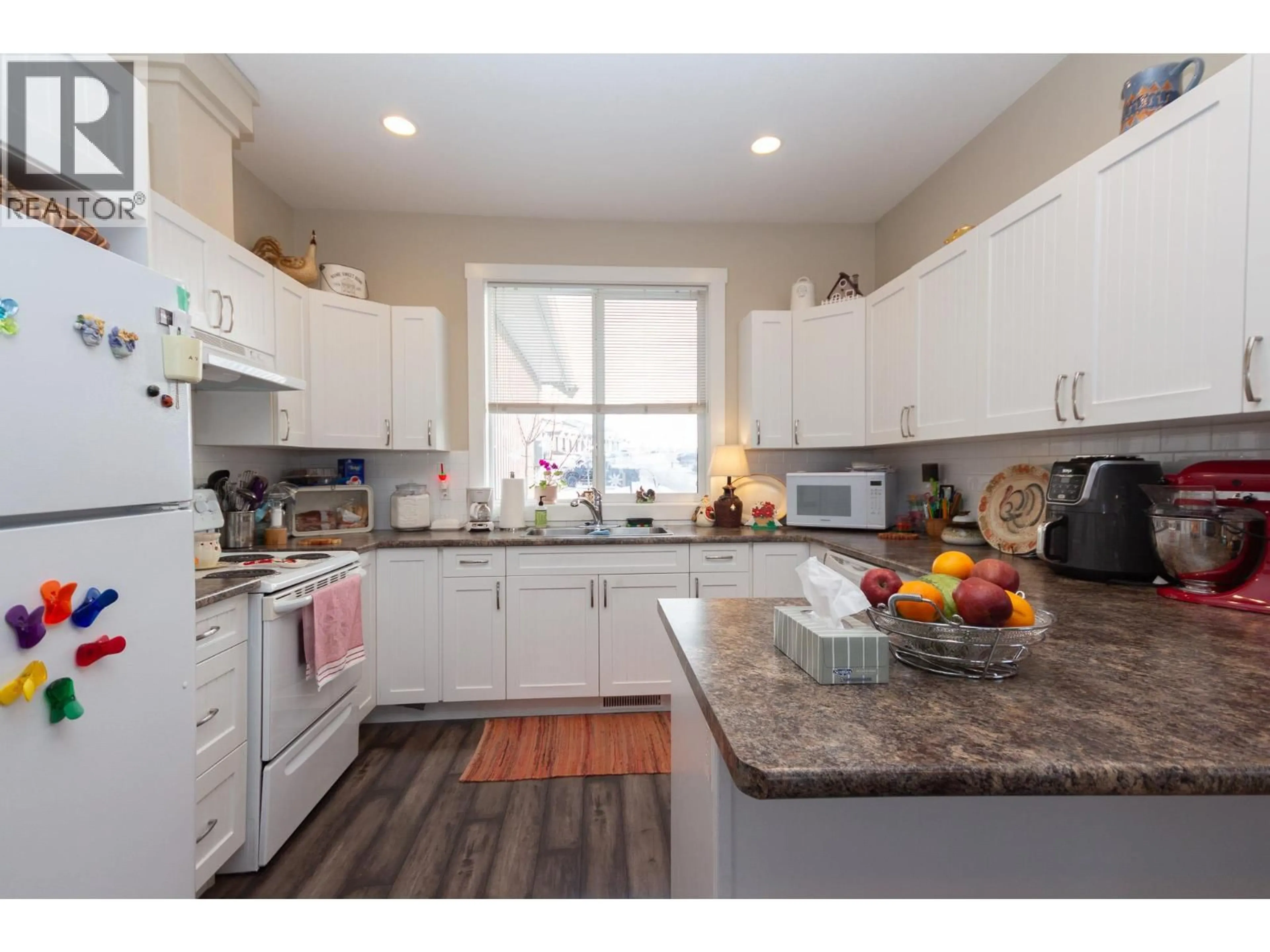 Open concept kitchen, wood/laminate floor for 8804 17 STREET, Dawson Creek British Columbia V1G0H2