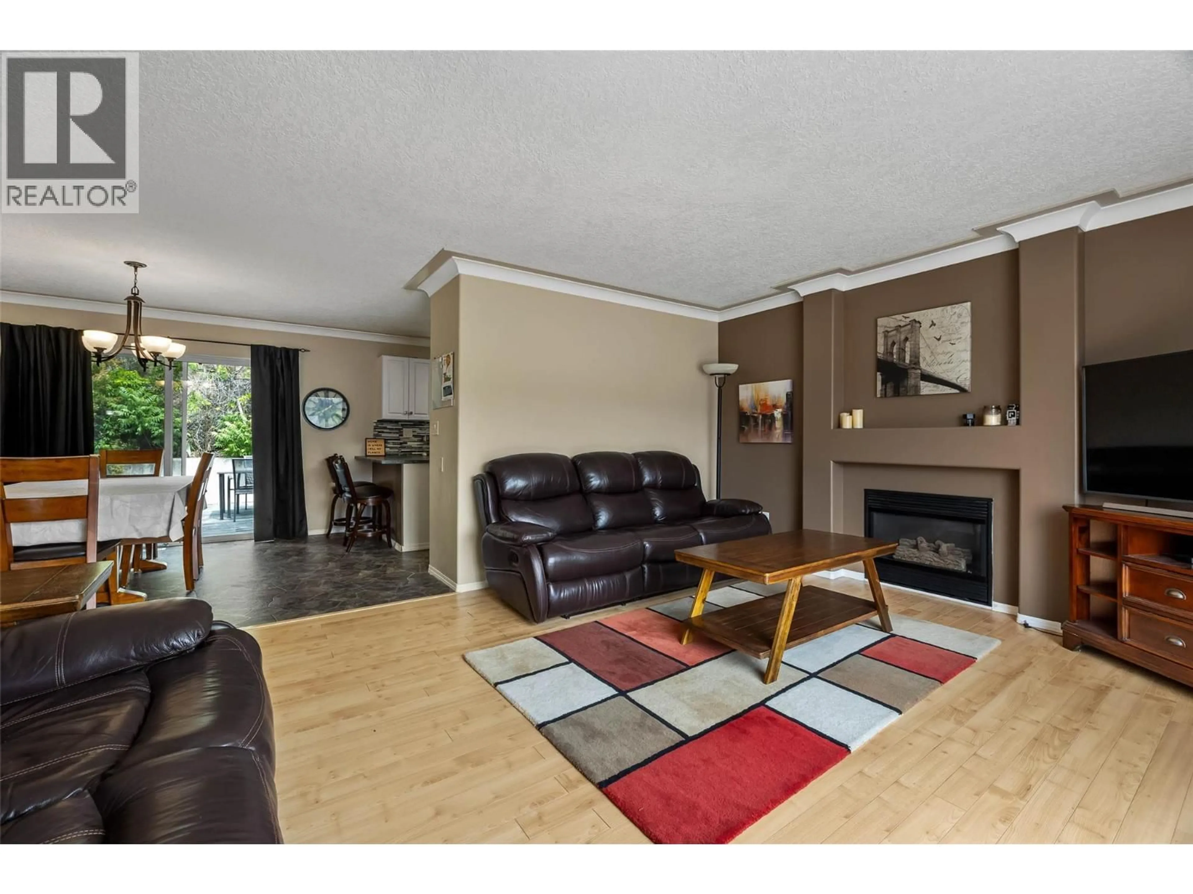 Living room with furniture, wood/laminate floor for 1374 SUNSHINE COURT, Kamloops British Columbia V2E2P9