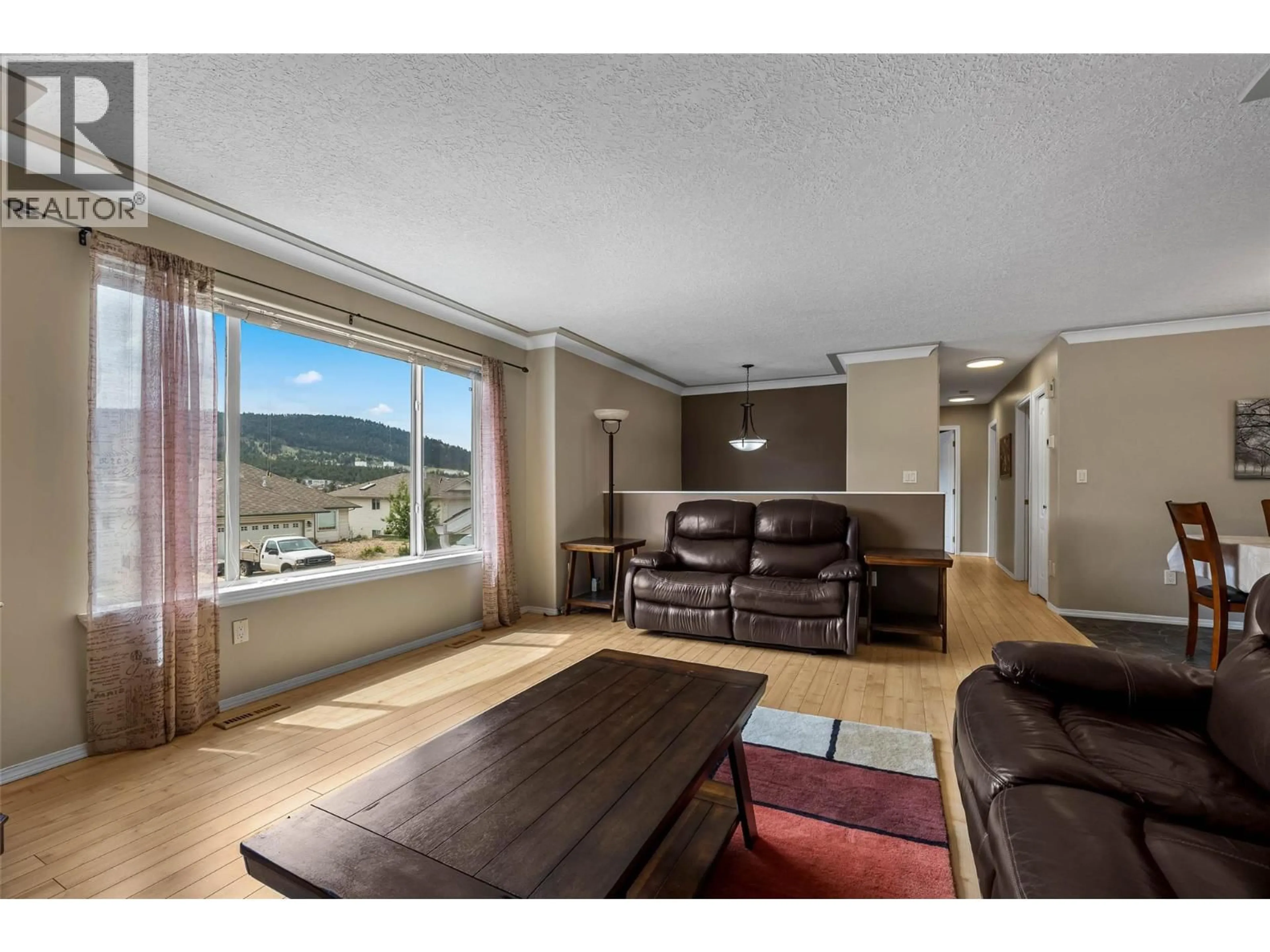 Living room with furniture, wood/laminate floor for 1374 SUNSHINE COURT, Kamloops British Columbia V2E2P9